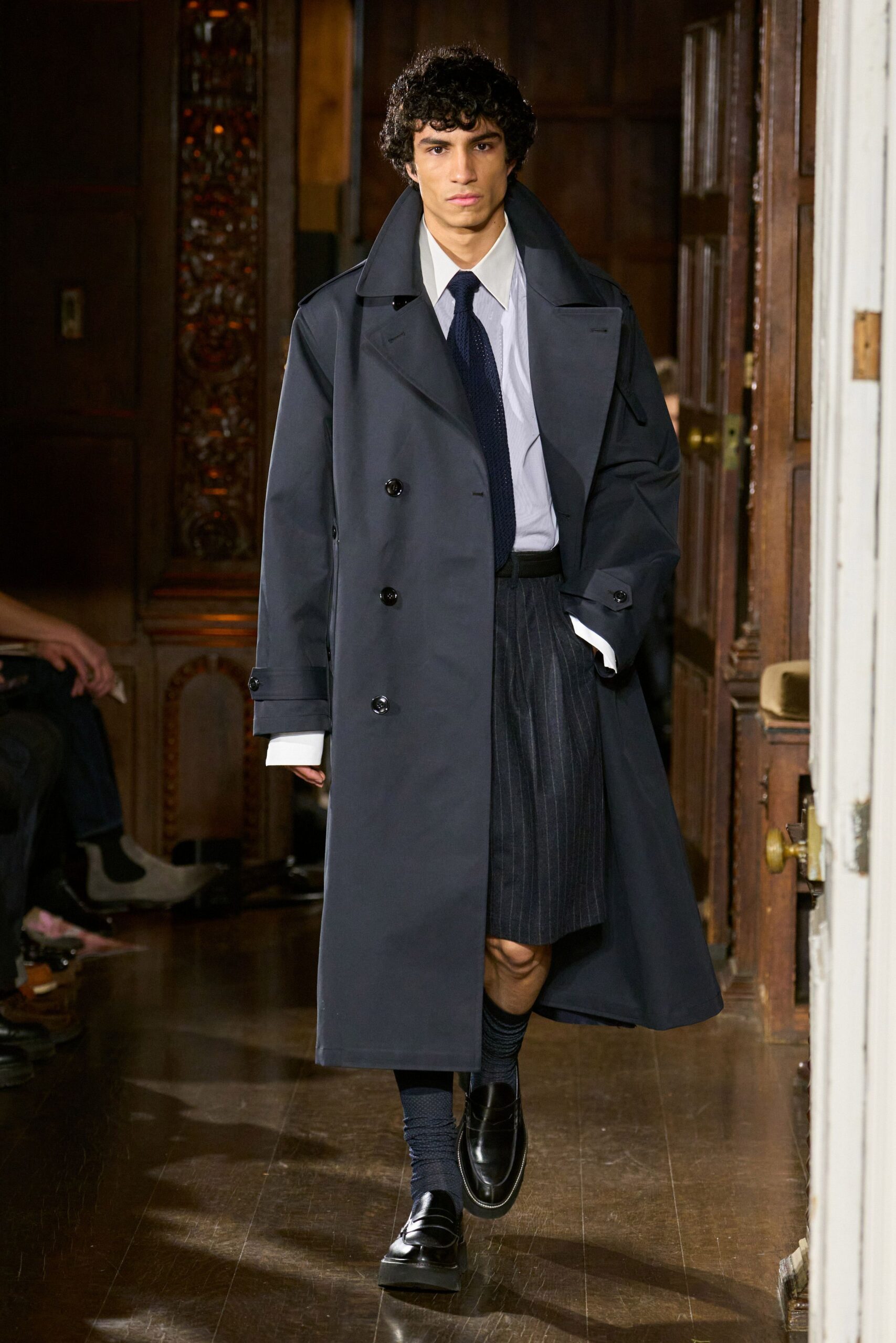 black coat white shirt gray pleated skirt