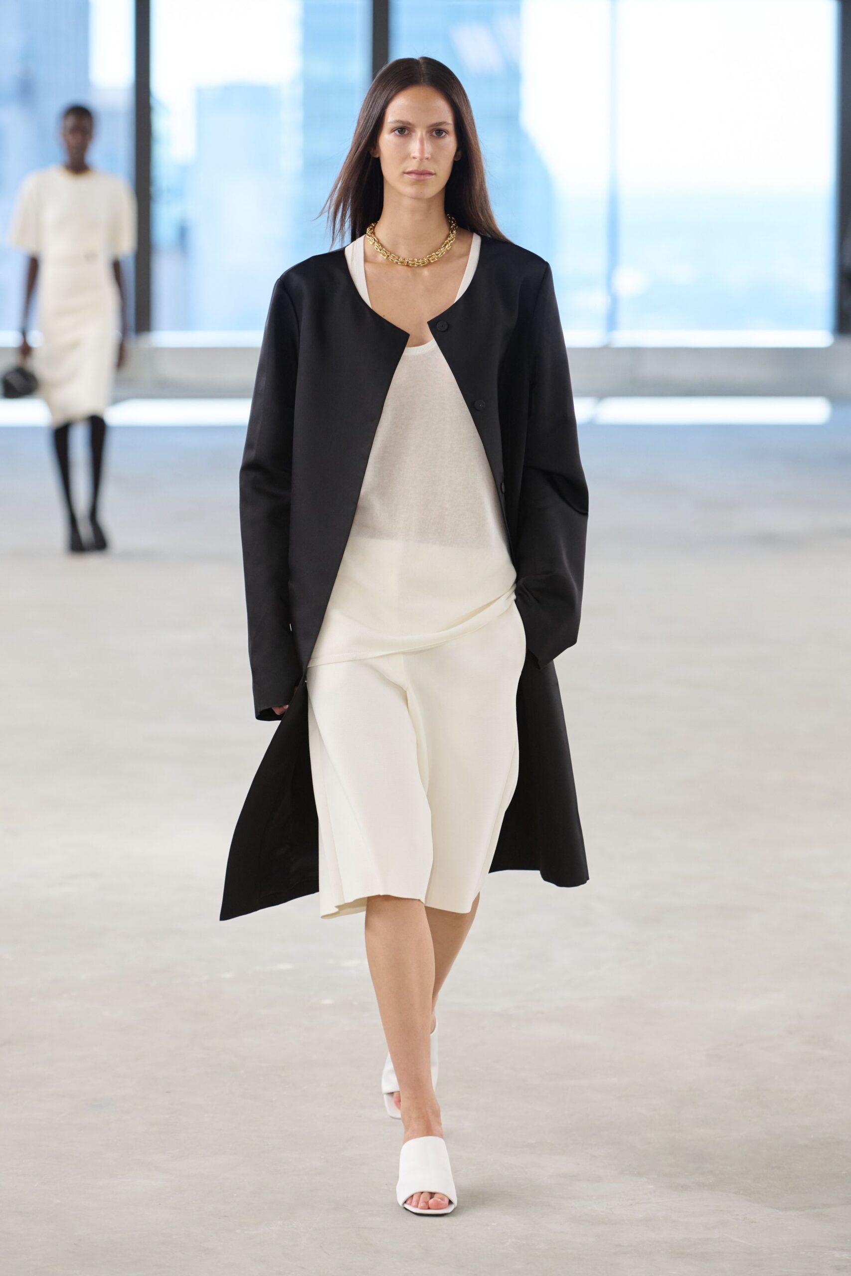black coat white top and skirt