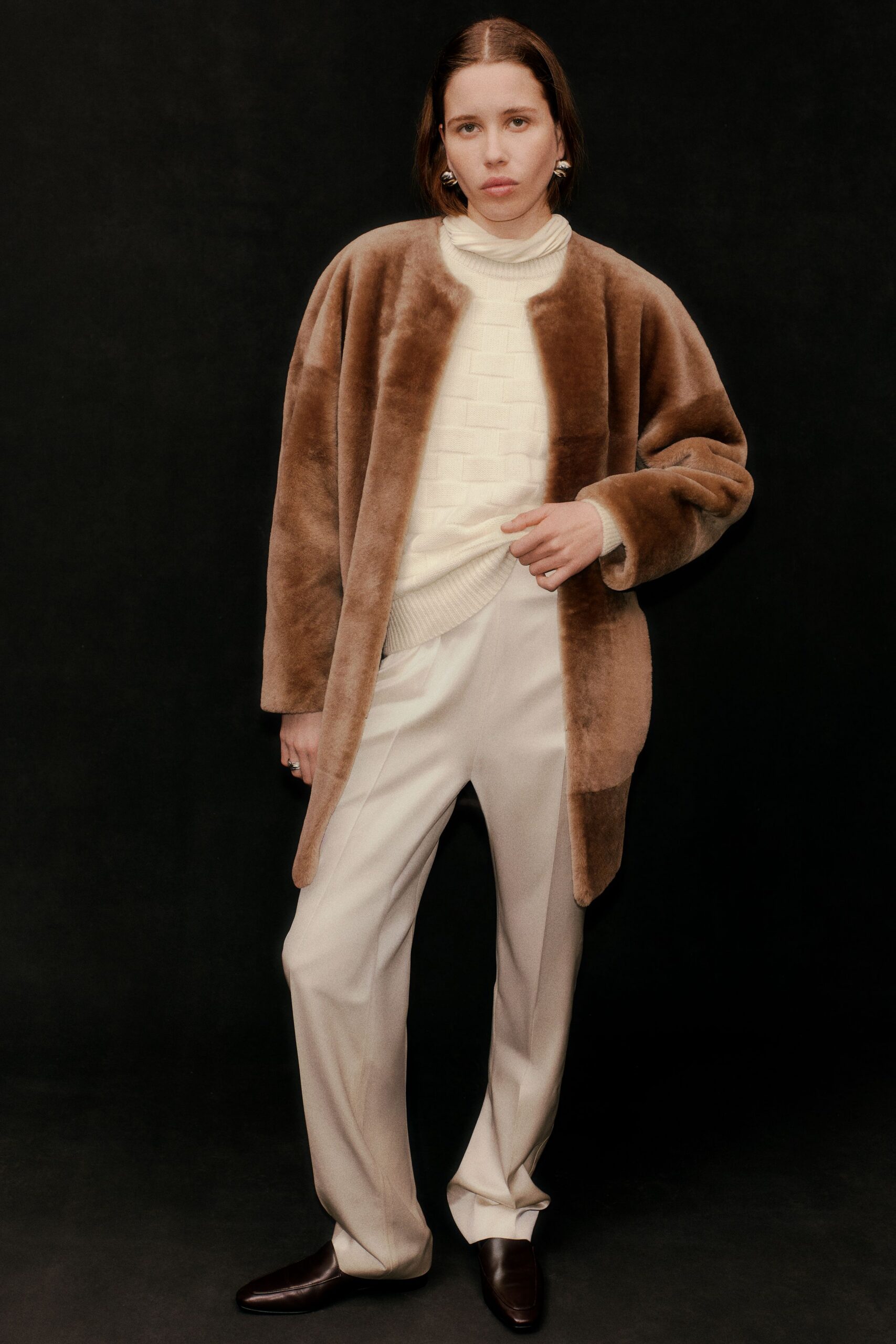 brown faux-fur coat with beige pants