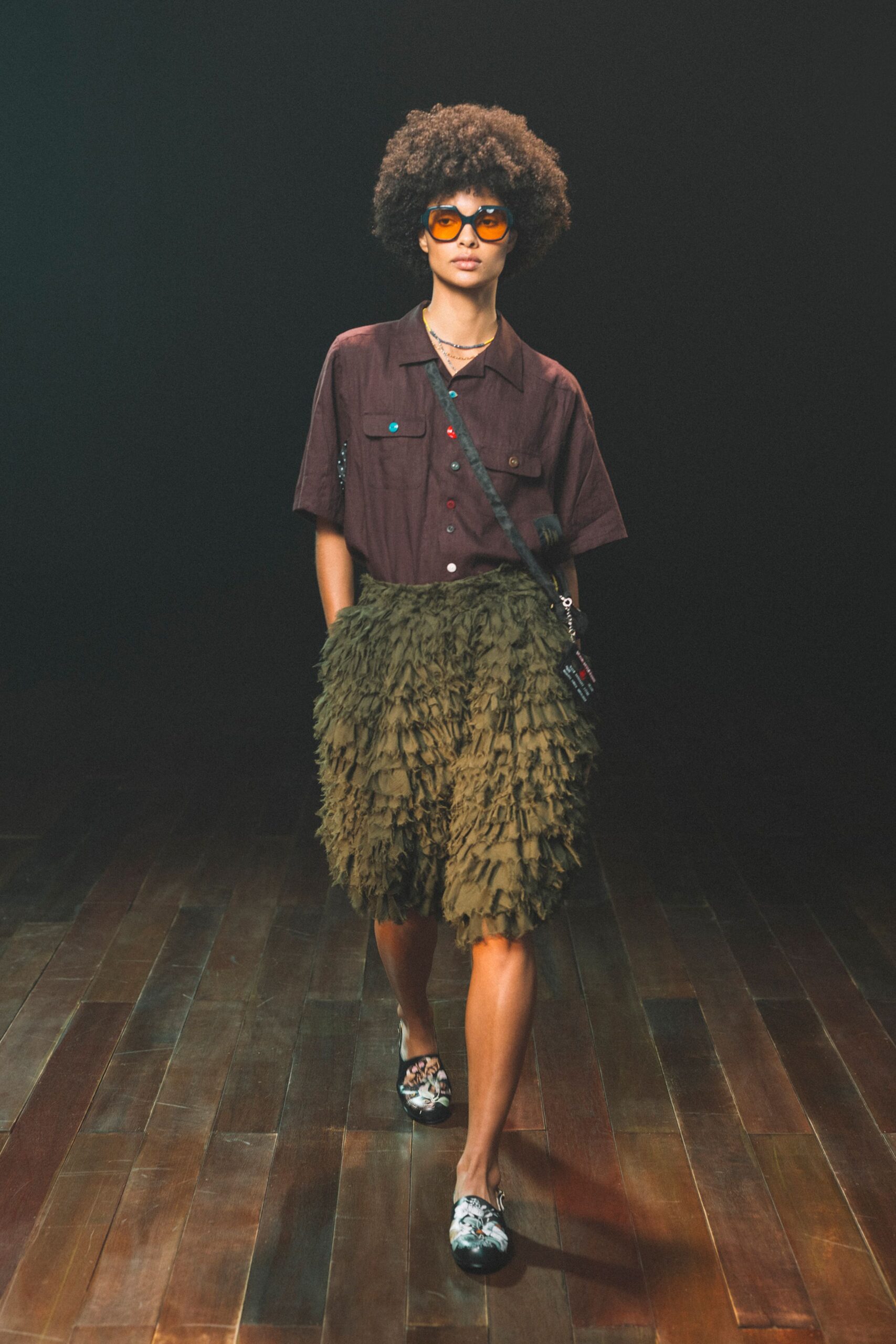 brown shirt green fringed skirt