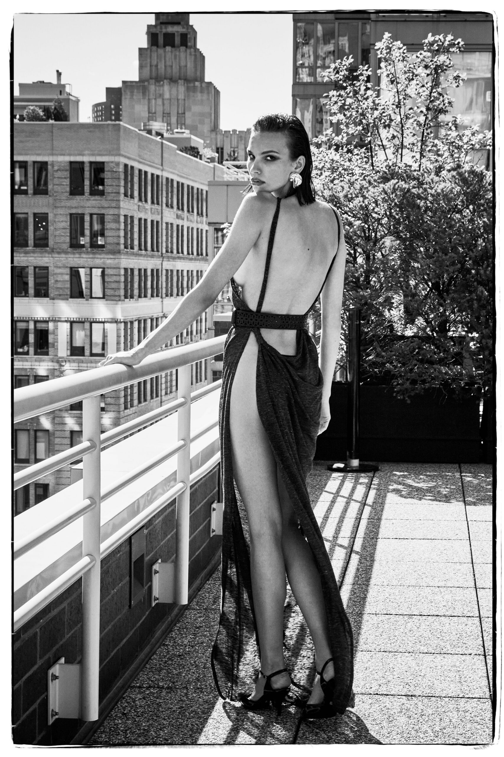 black silk sleeveless backless fitted draped flowing gown