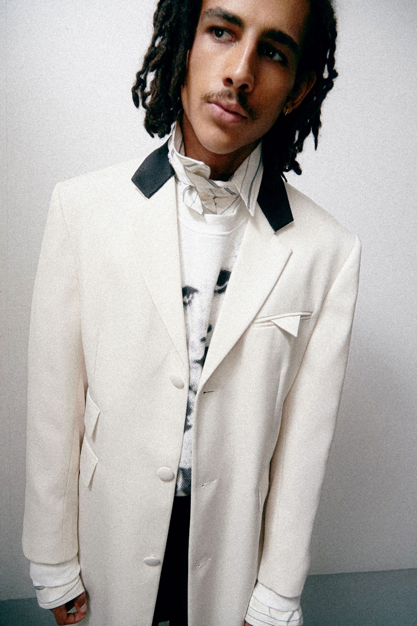 white tailored blazer with gray sweater
