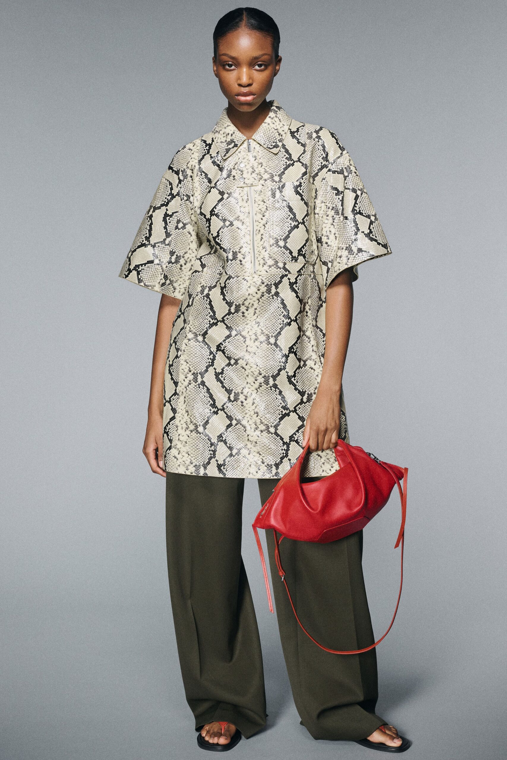 beige printed top with green pants