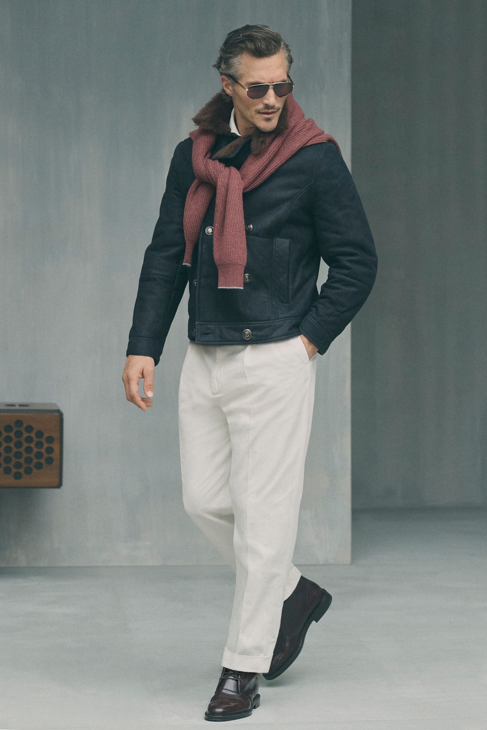 black jacket red sweater white pants