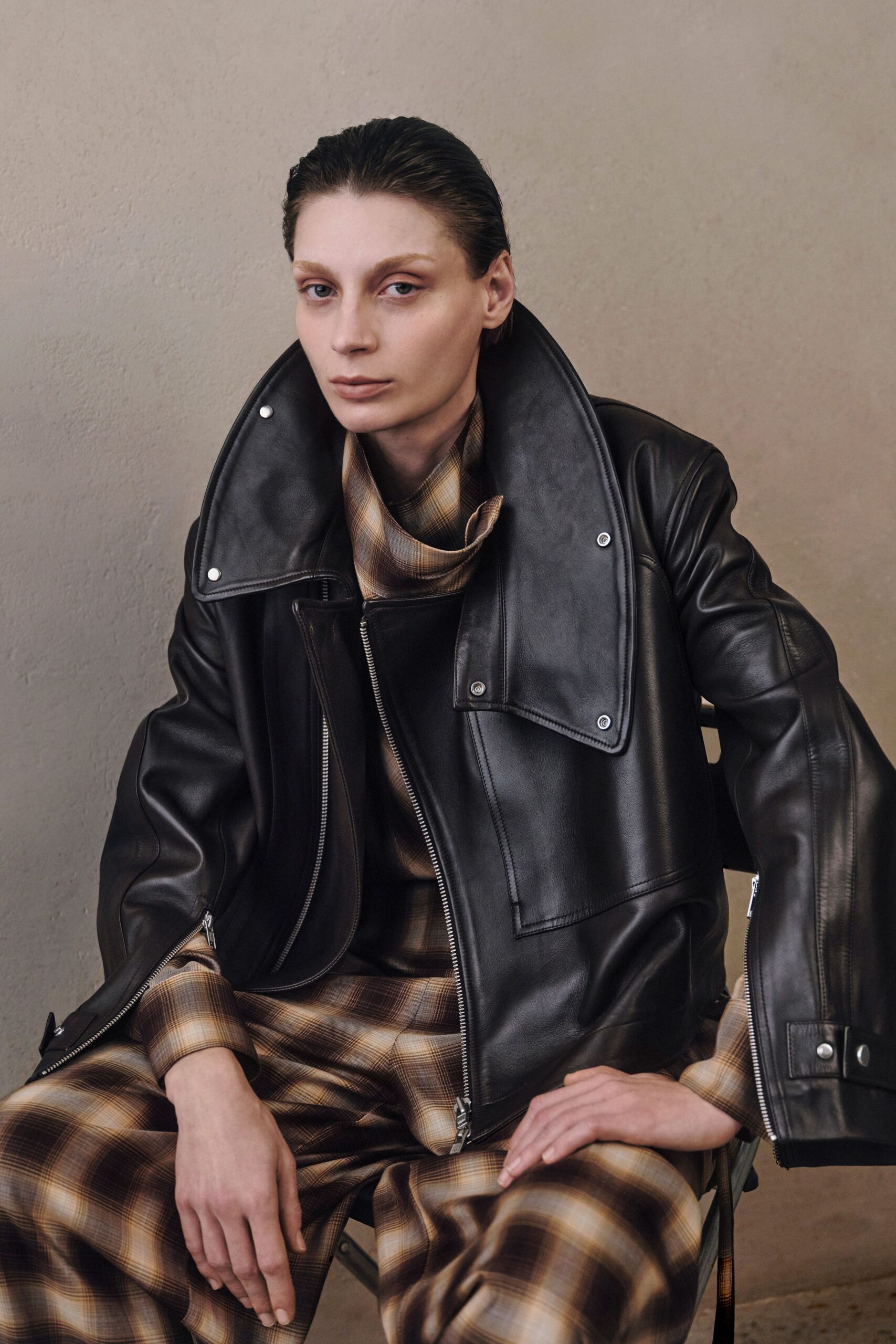 black leather jacket with checked pants