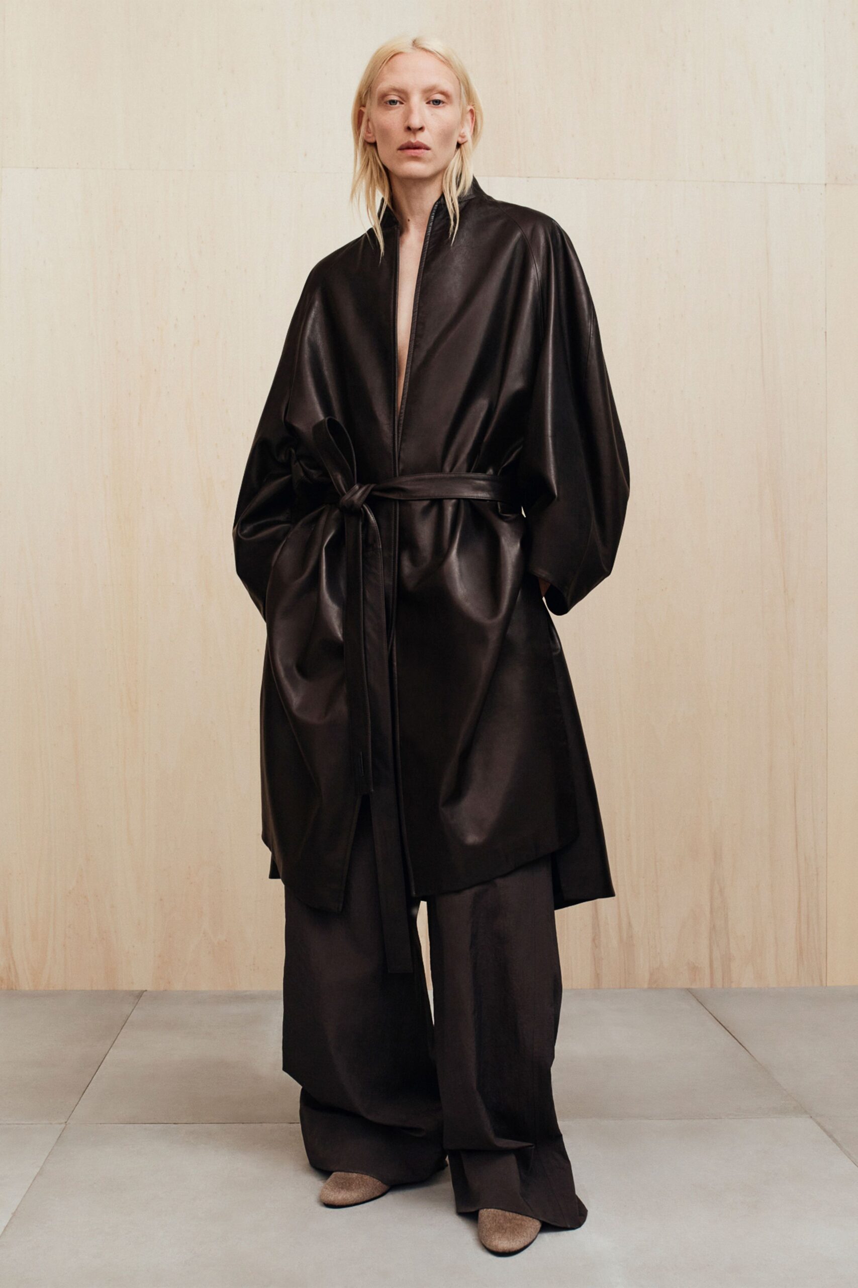 black leather long-sleeve collared relaxed belted coat