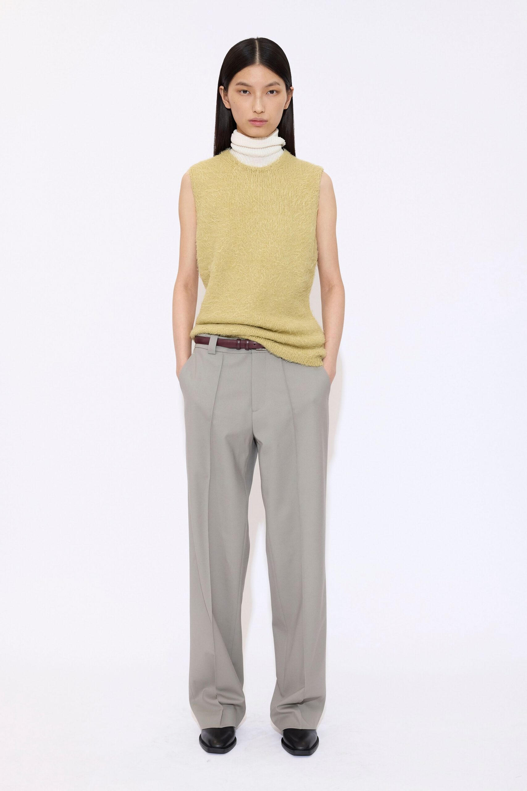yellow sleeveless top with gray pants