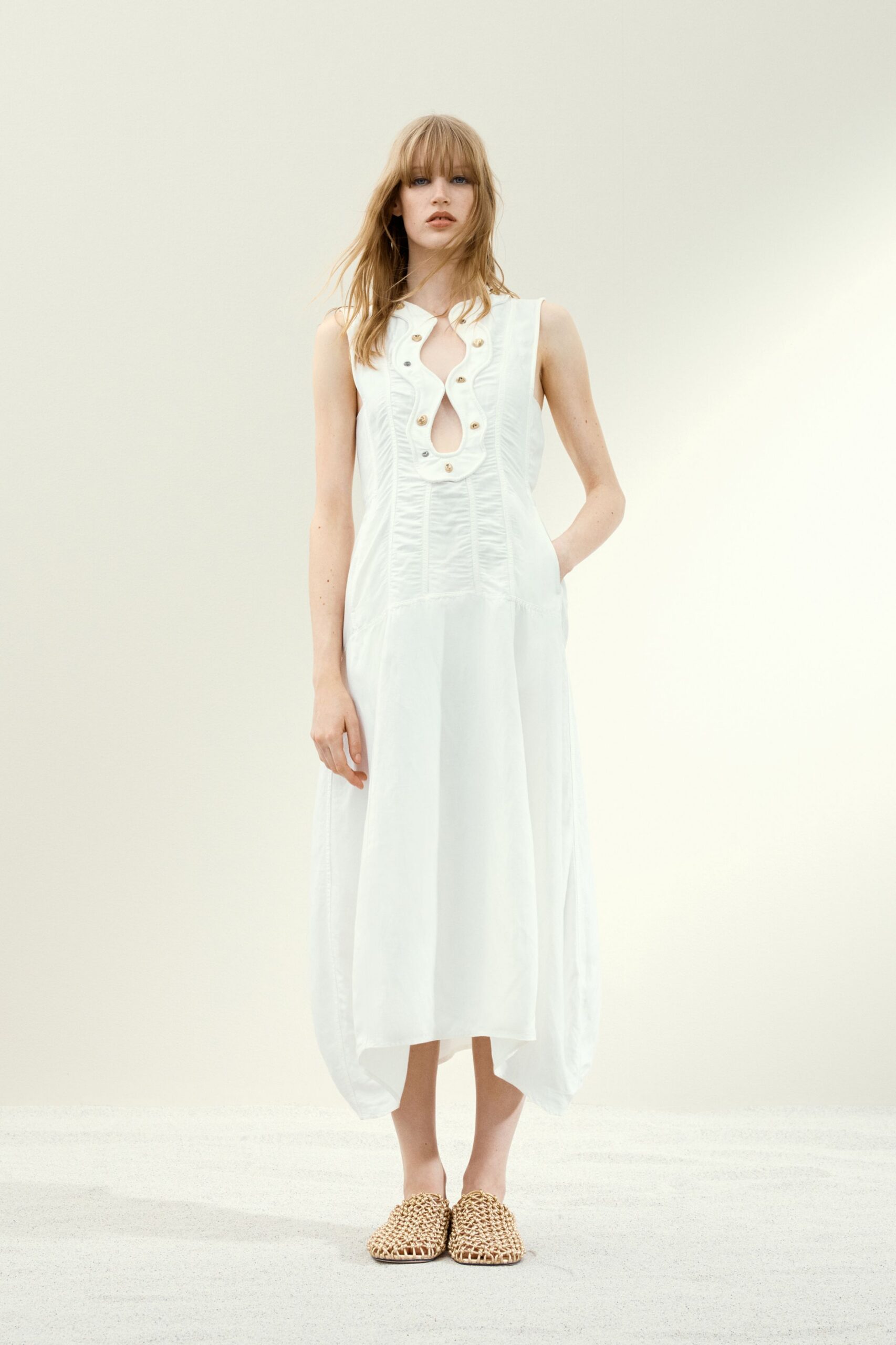 white cotton sleeveless v-neck relaxed buttoned pleated dress