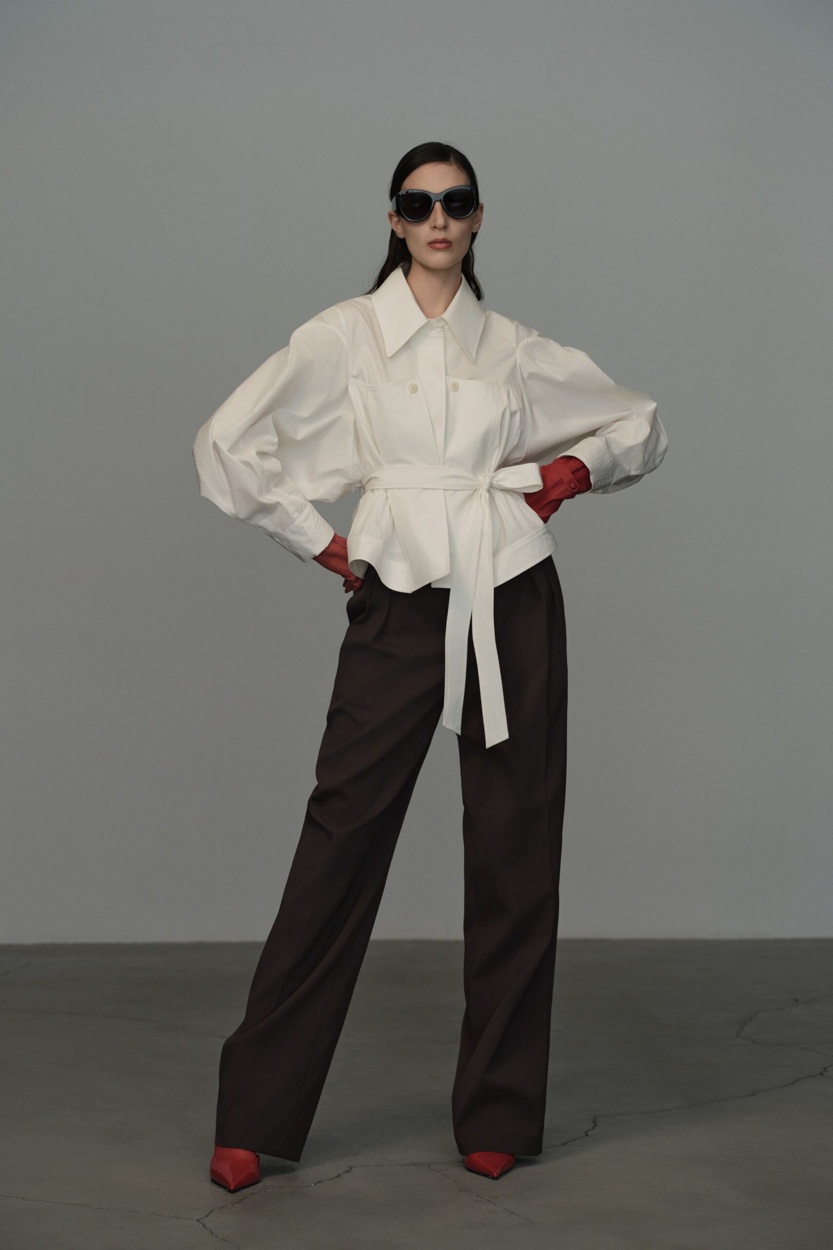 white shirt brown pants red accessories