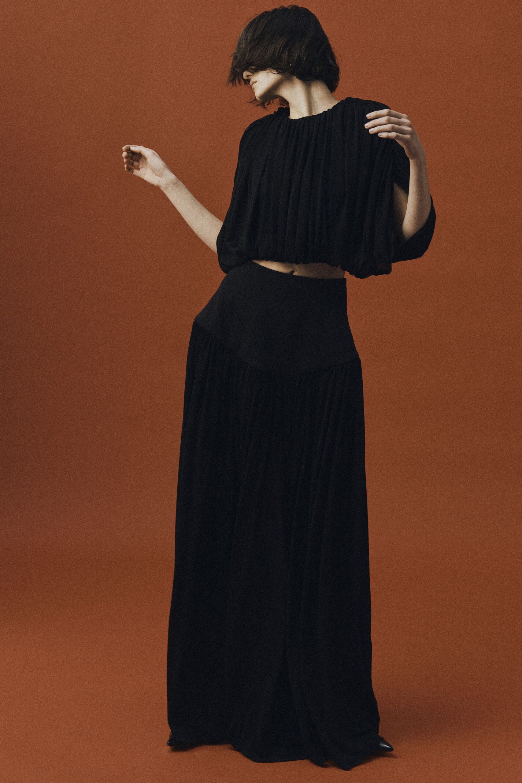 black silk short-sleeve high-neck relaxed pleated cropped top