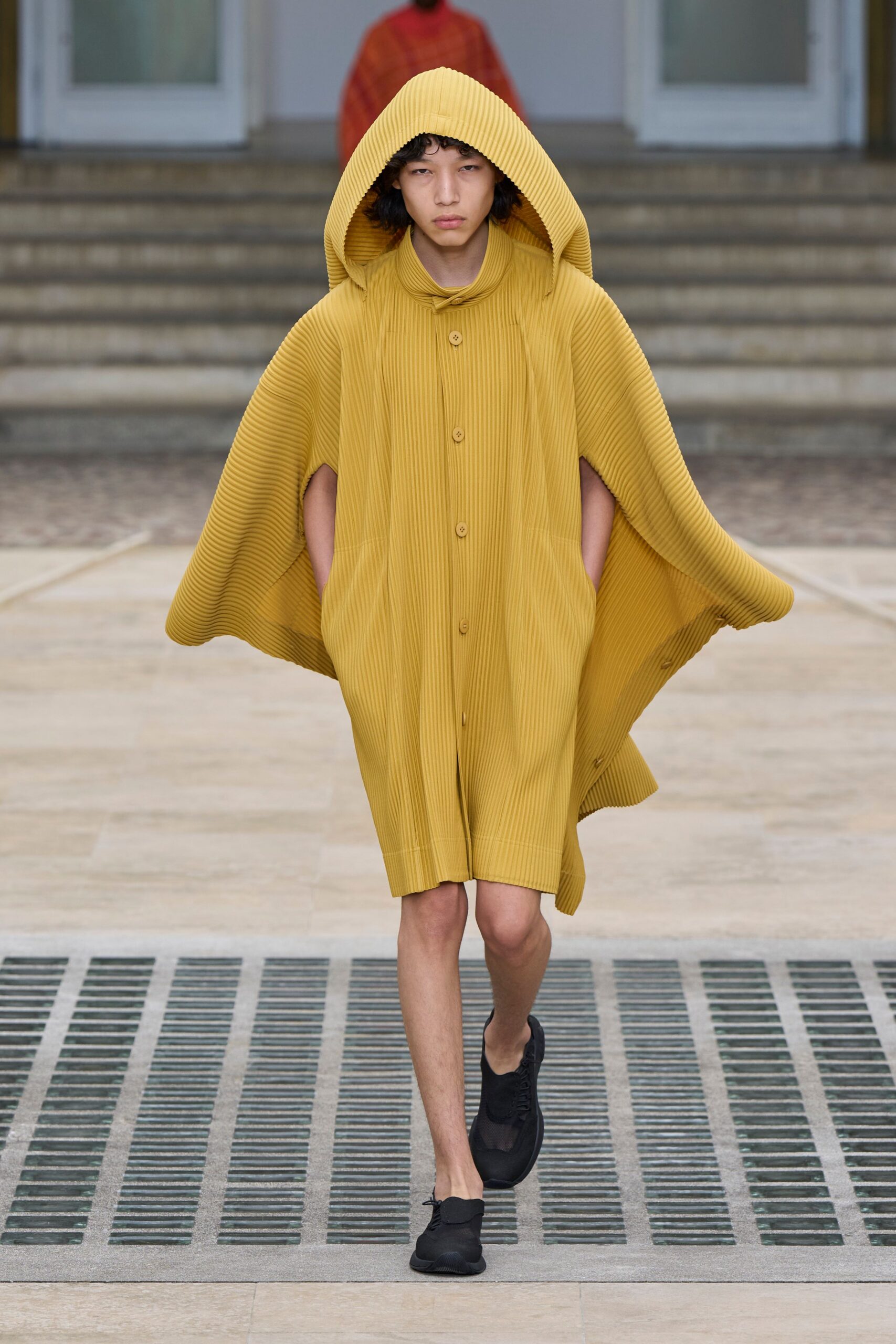 yellow pleated poncho with black shoes