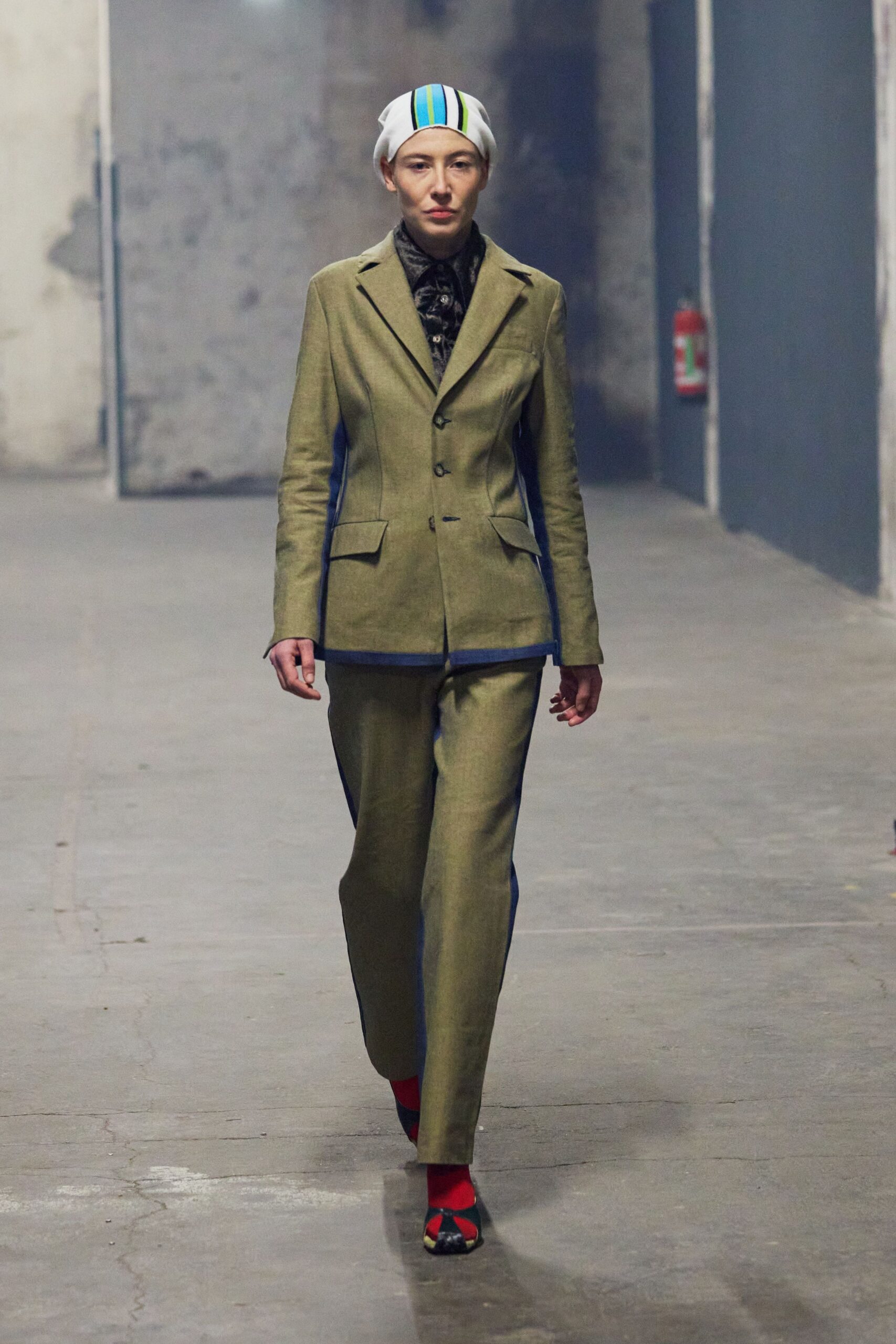 green tailored suit with red shoes