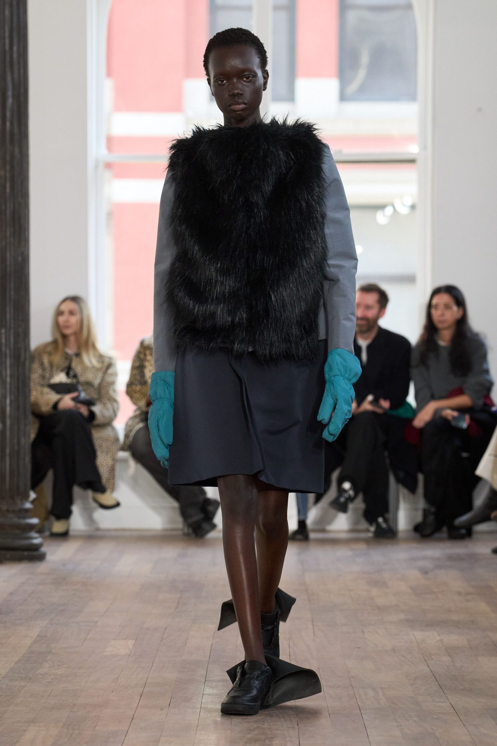 gray faux-fur top with black skirt