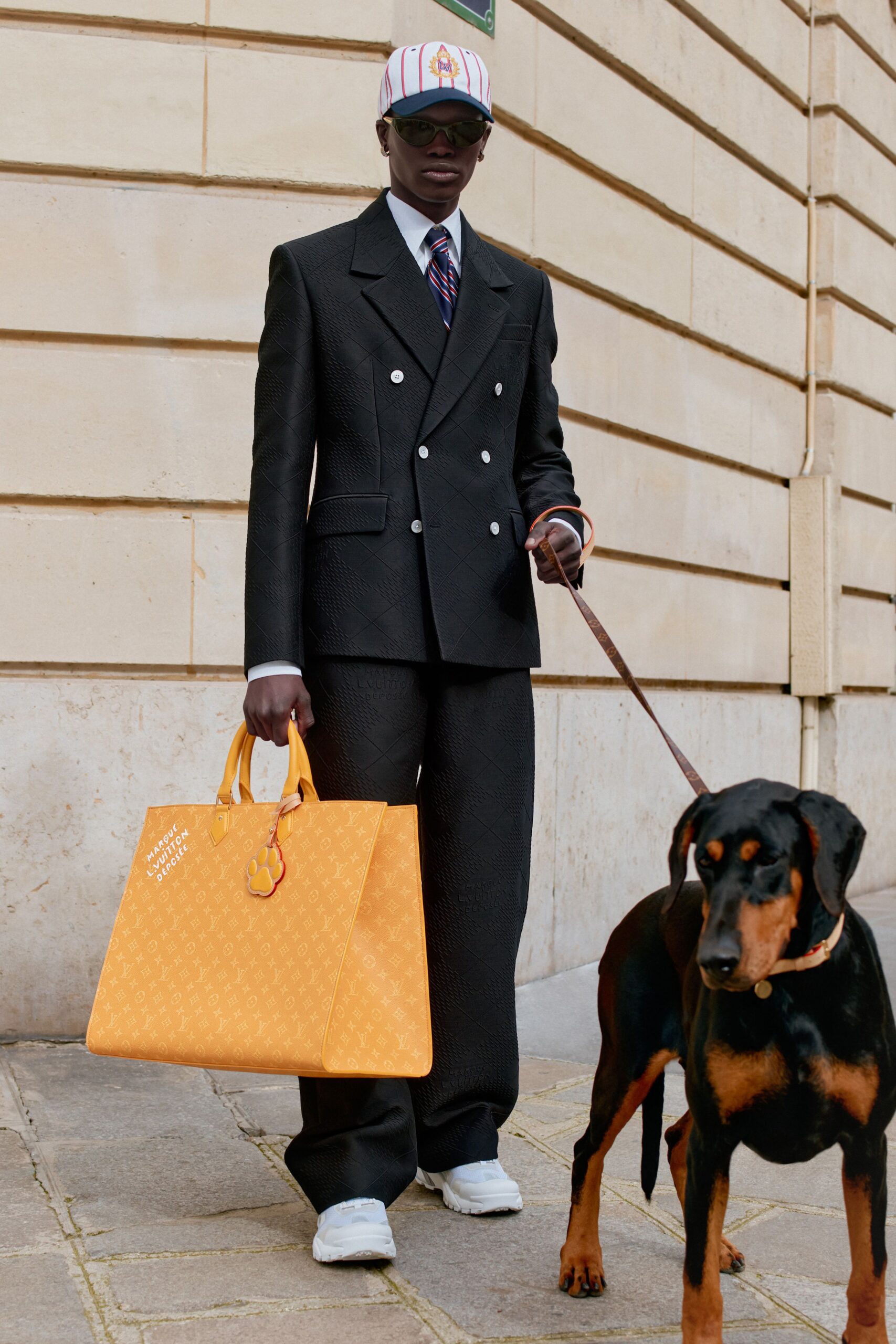 black tailored suit with orange bag