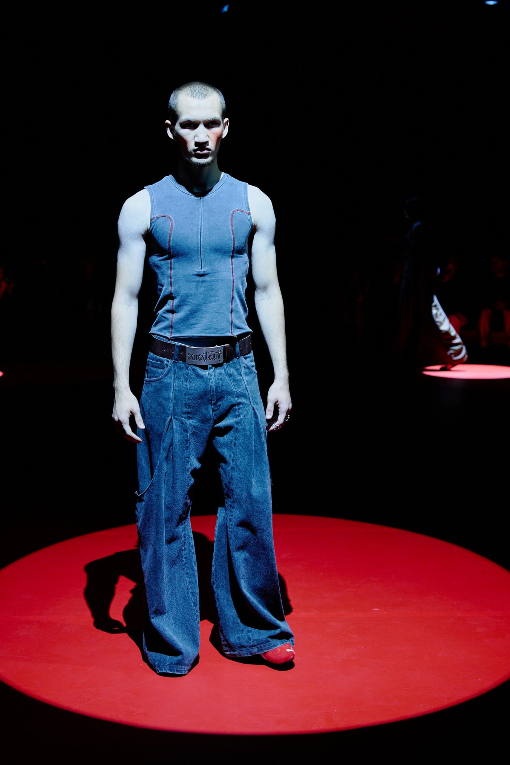 blue fitted sleeveless top with relaxed denim pants