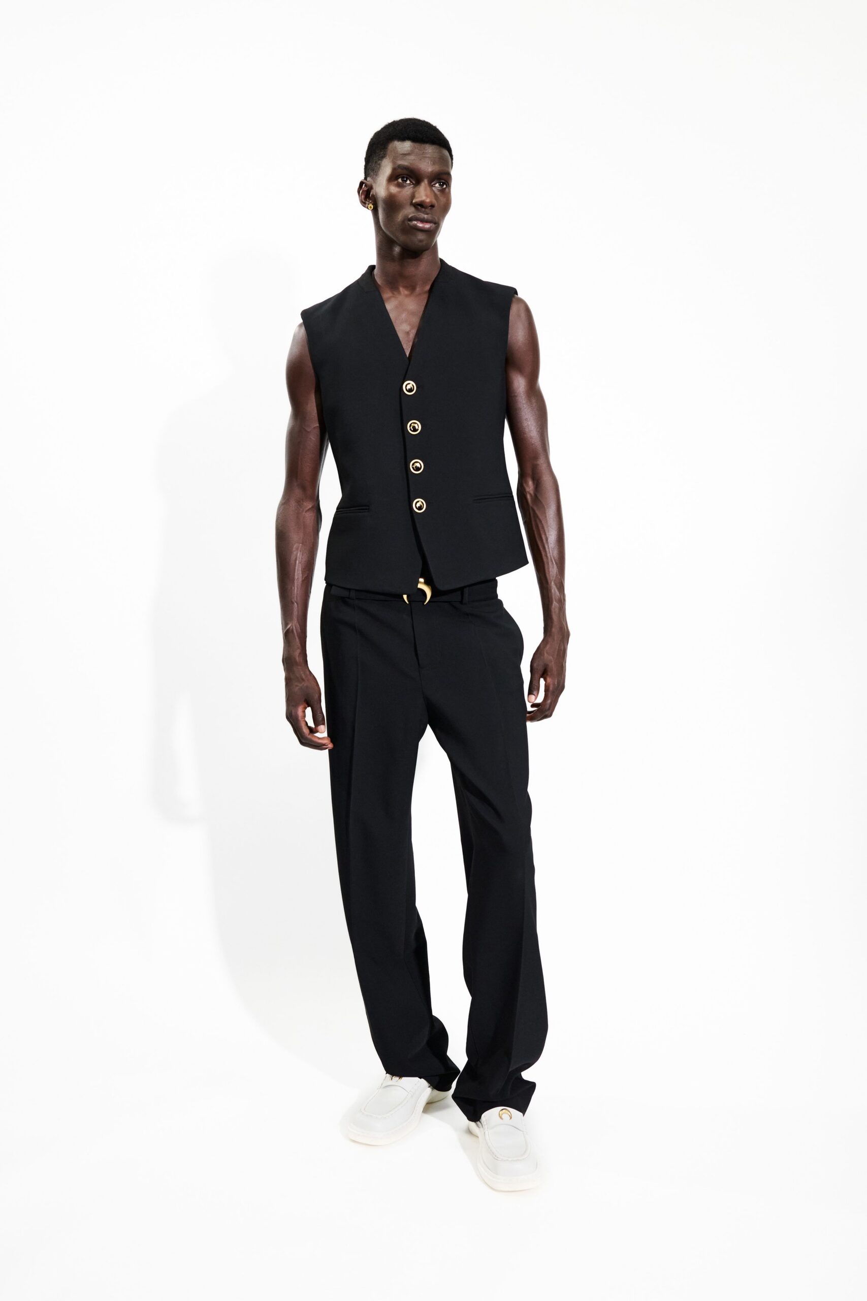 black fitted vest with tailored pants