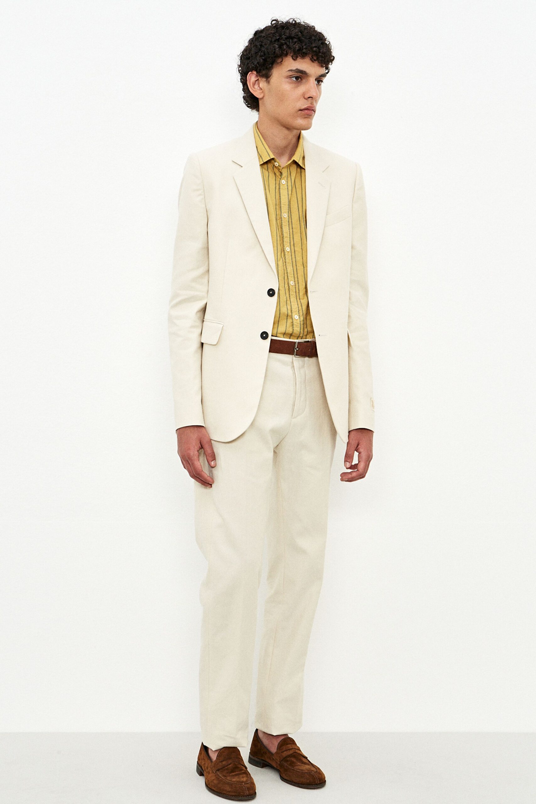 beige tailored suit with yellow shirt