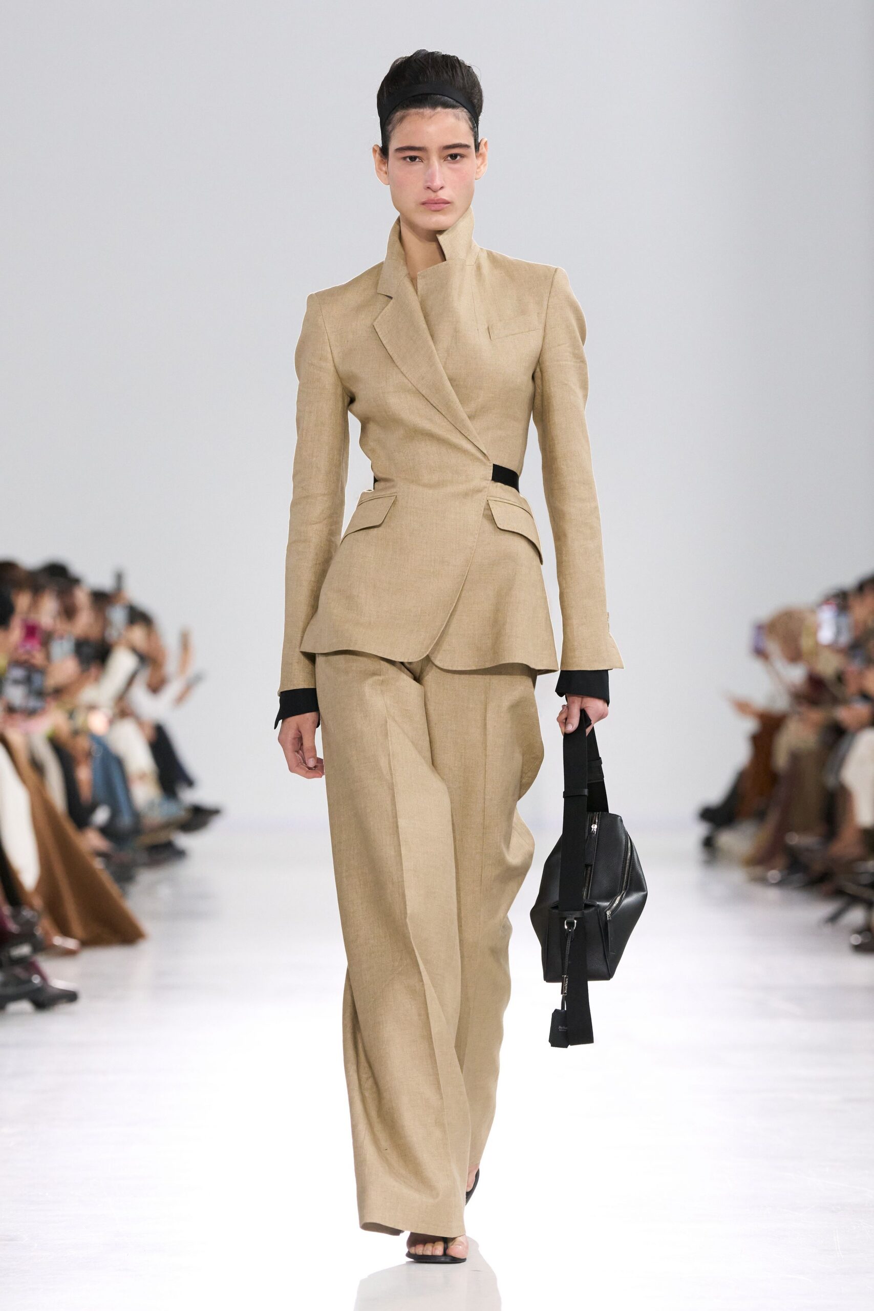 beige tailored suit with black bag