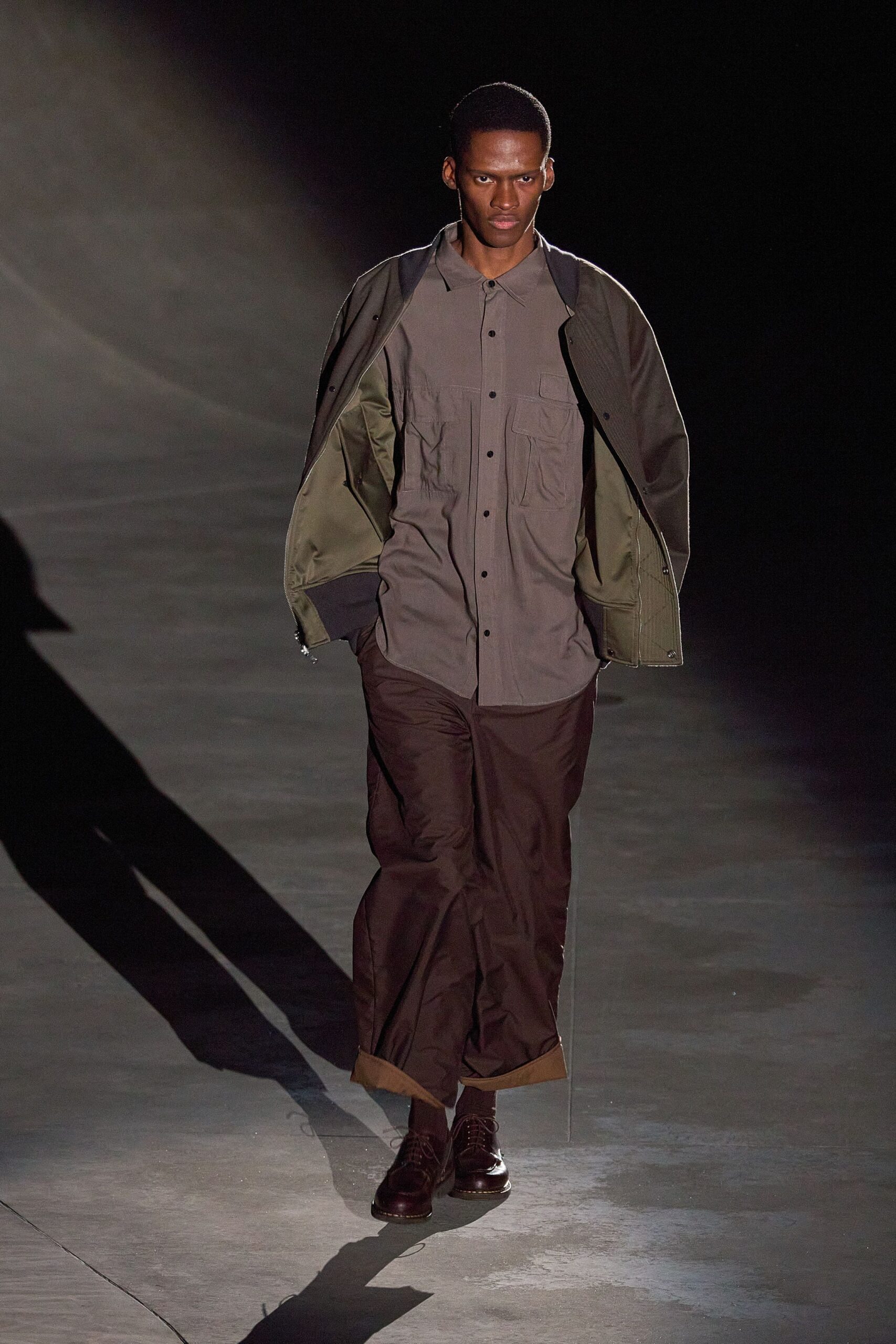 green jacket gray shirt brown pants
