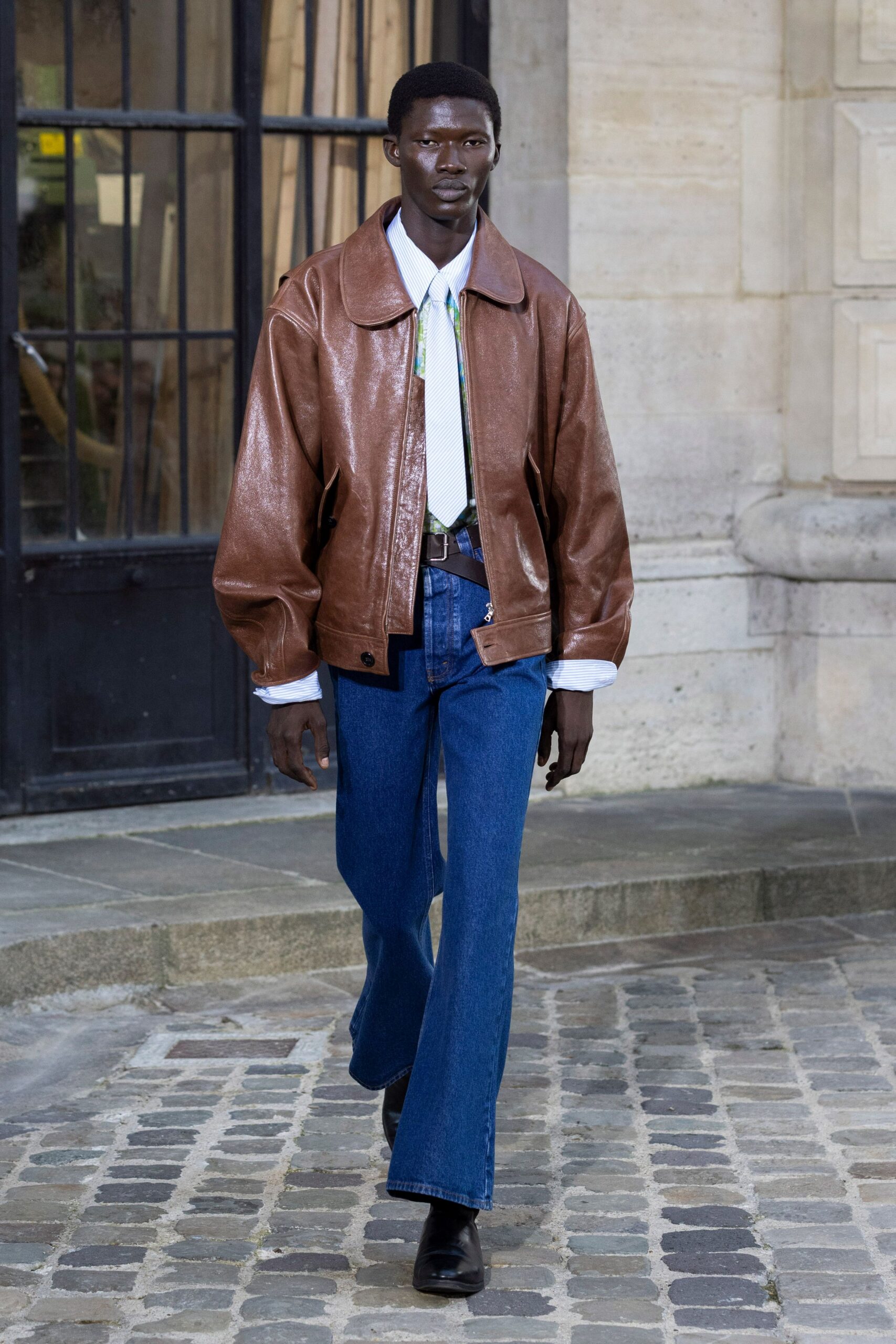 brown leather jacket with blue jeans