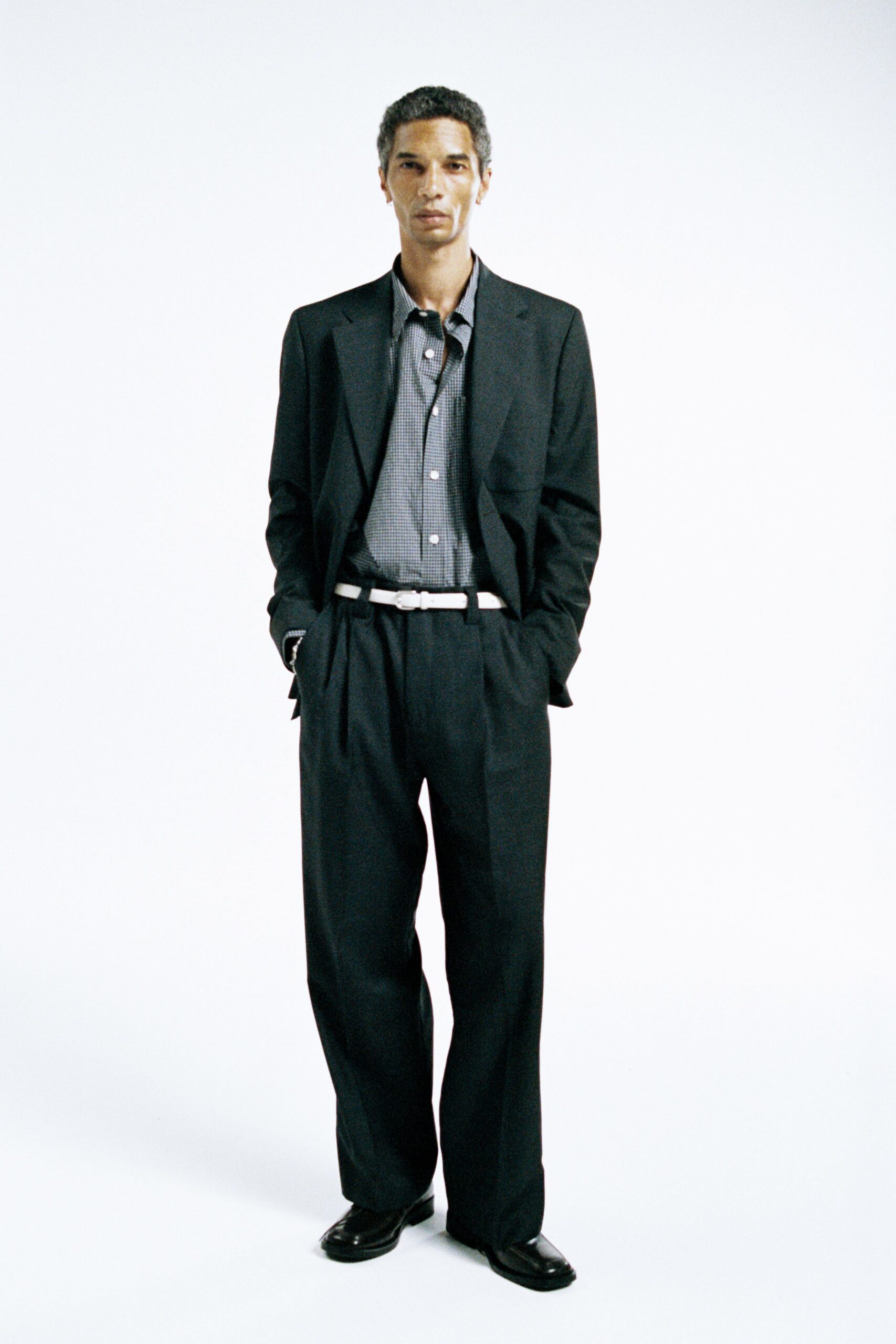 black tailored suit with gray shirt