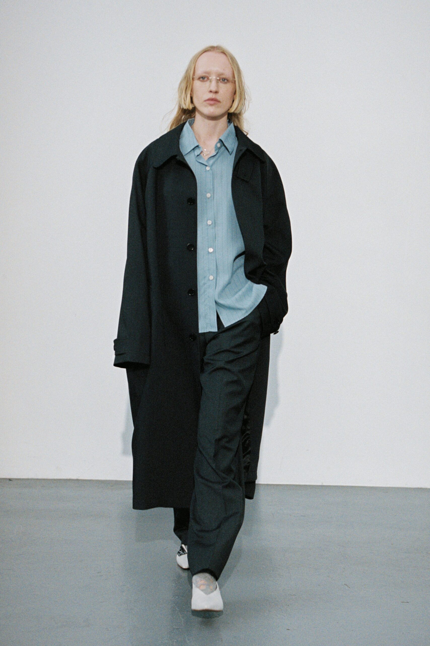 black coat blue shirt tailored pants