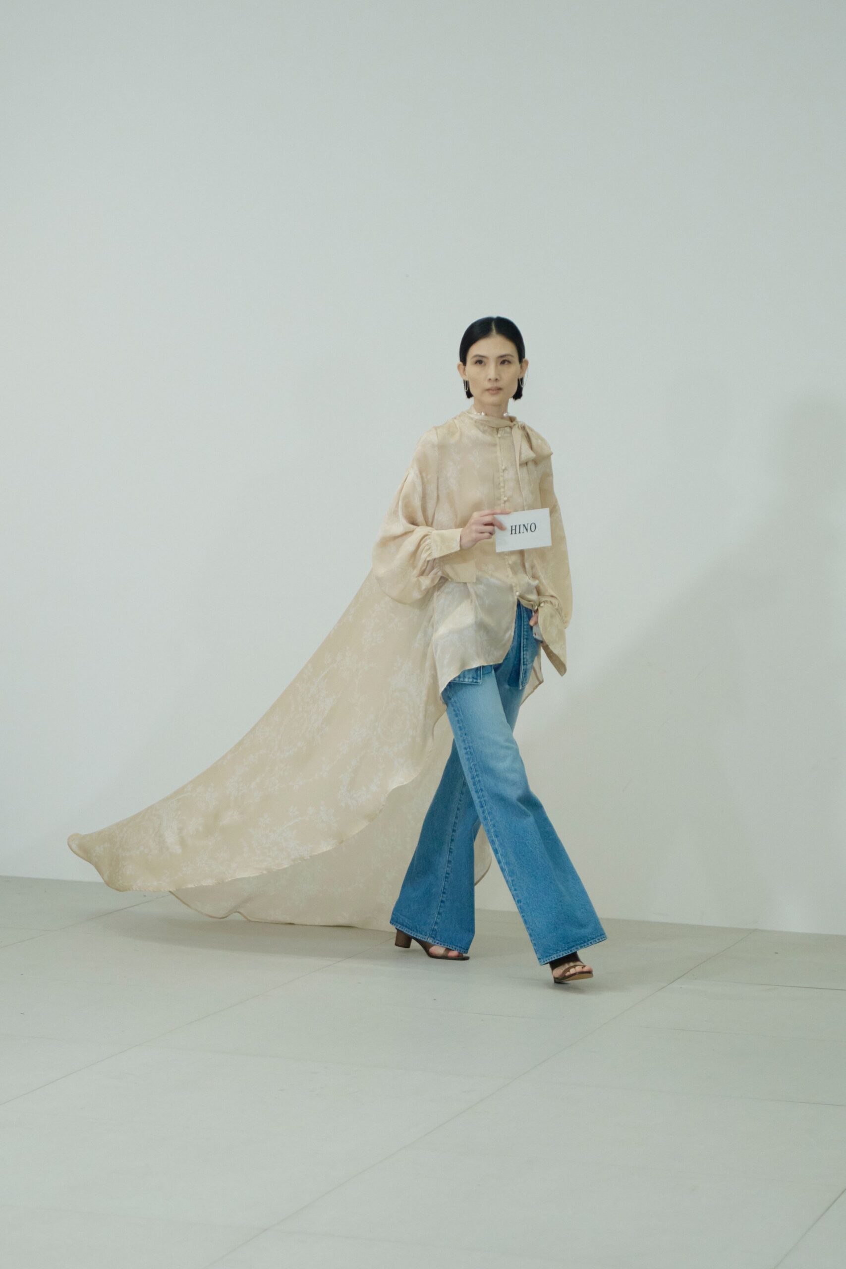 beige silk top with wide-leg jeans