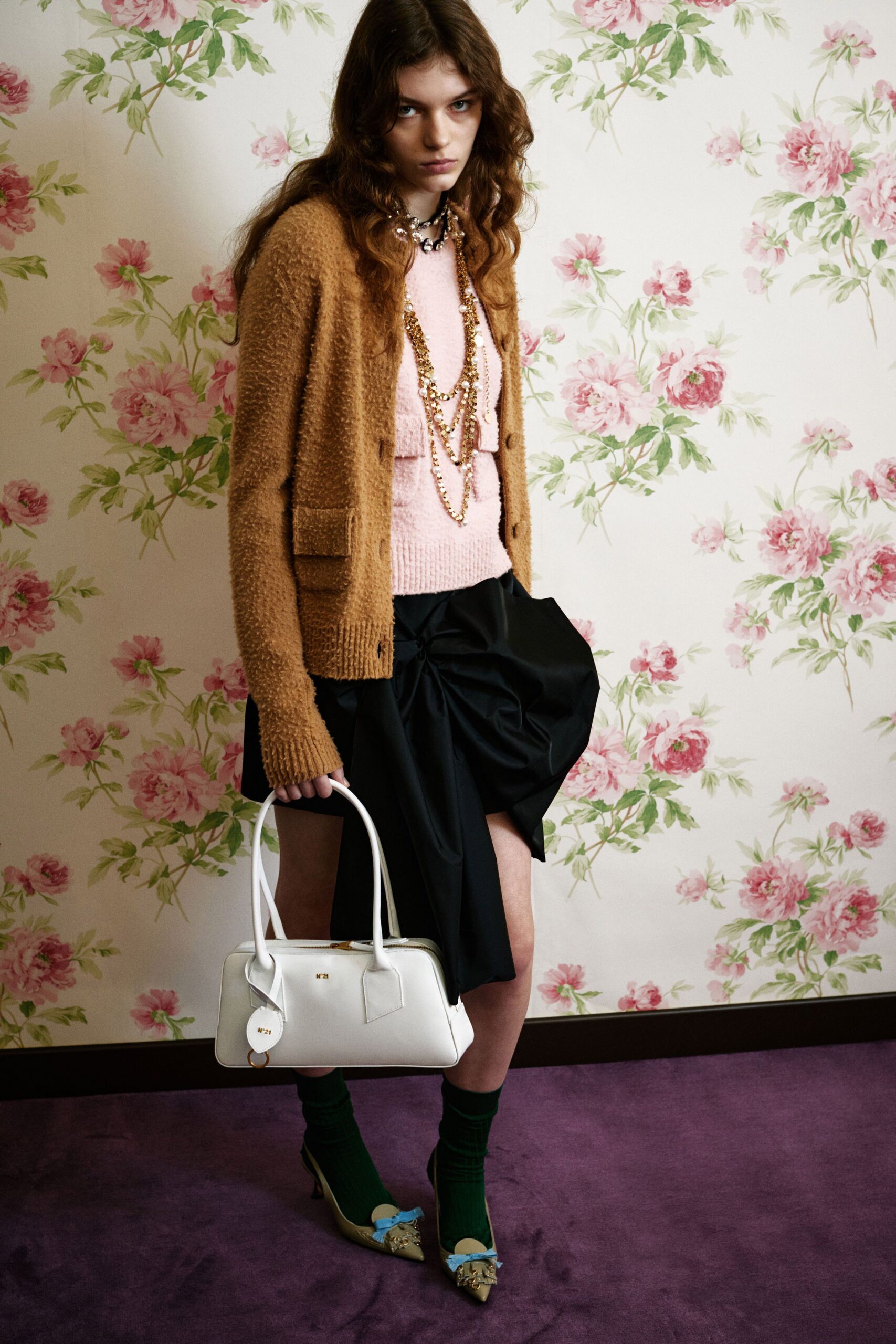 brown cardigan pink sweater black skirt