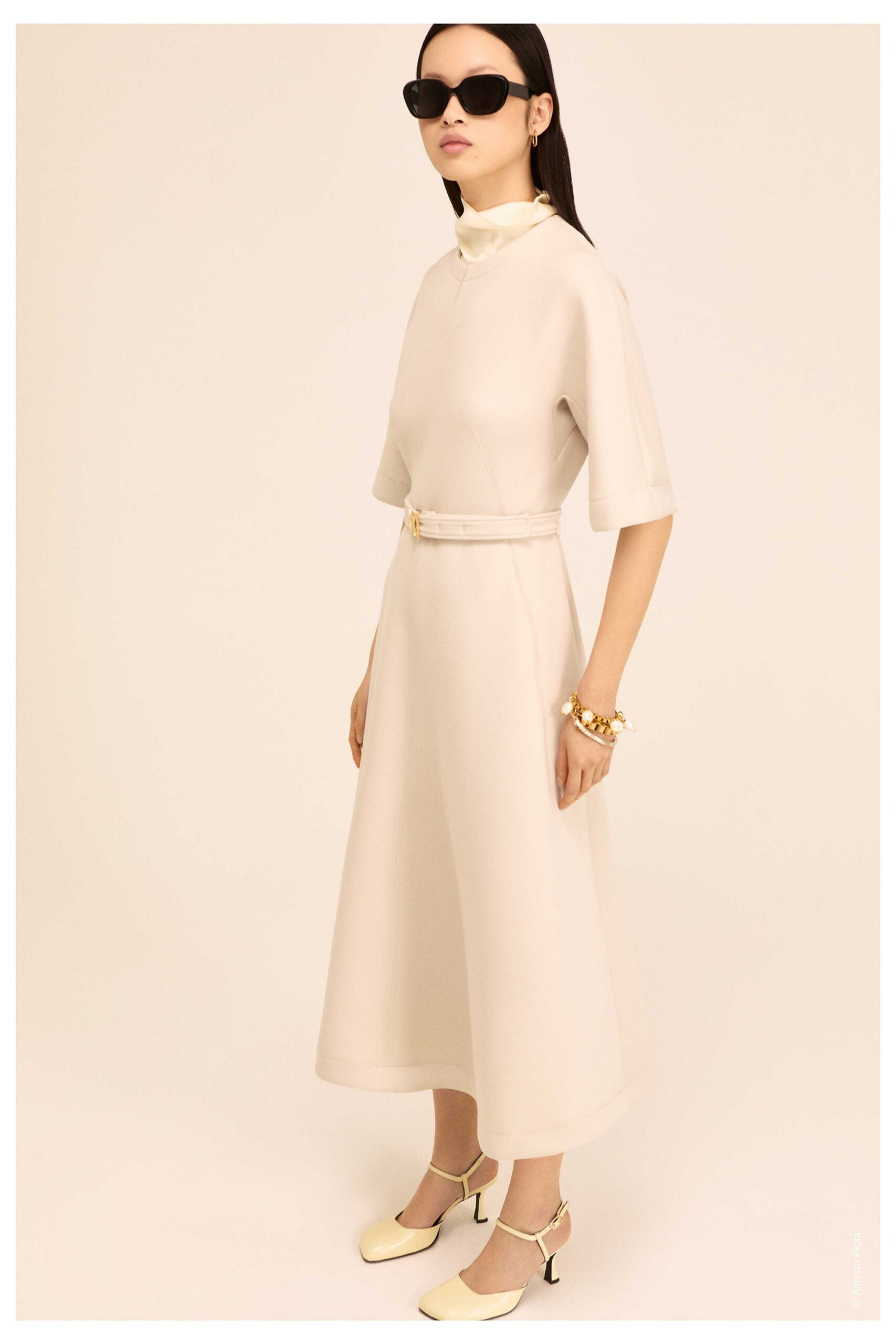 beige belted midi dress with sunglasses