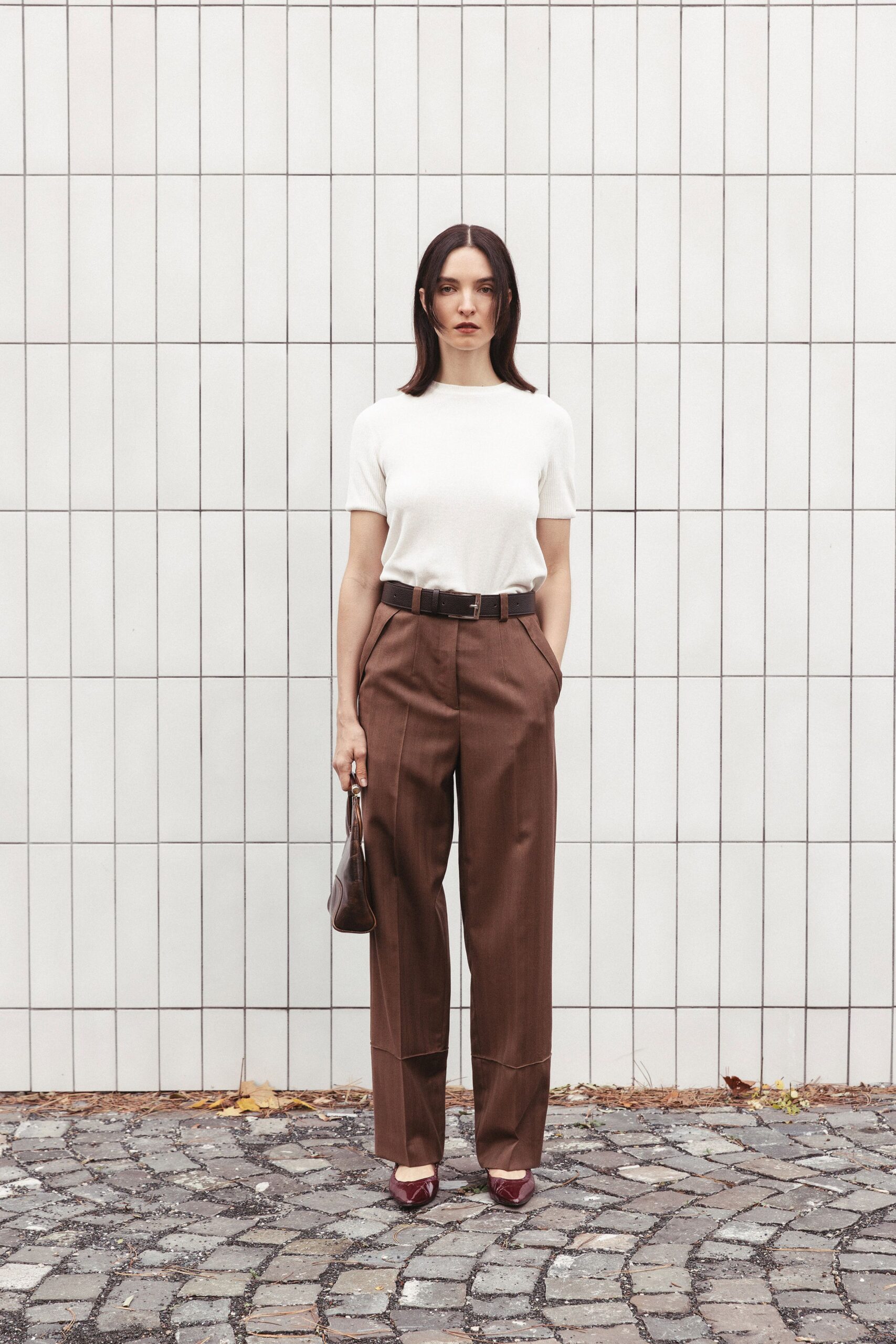 white fitted top with brown pants