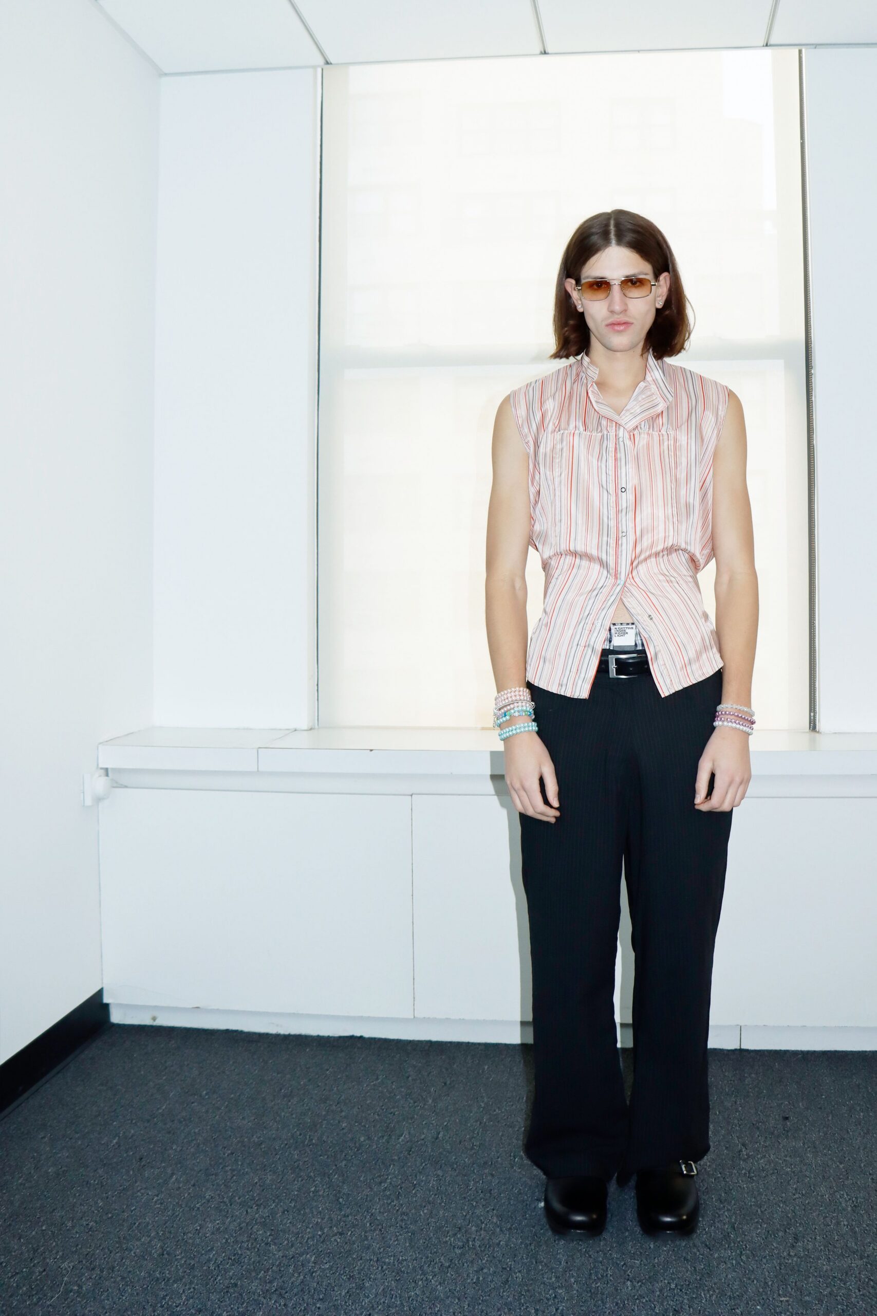 pink striped sleeveless shirt with black pants