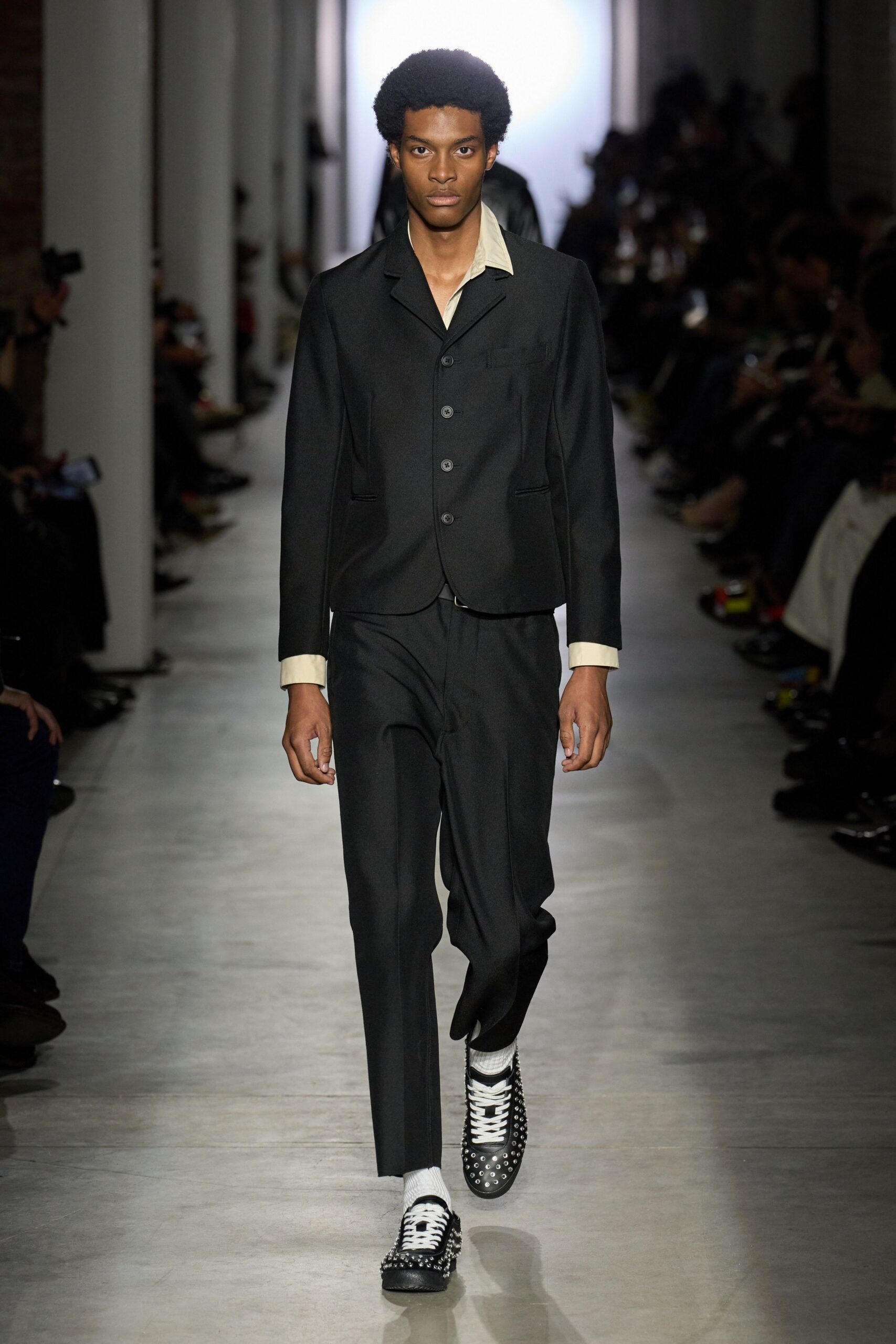 black tailored suit with beige shirt
