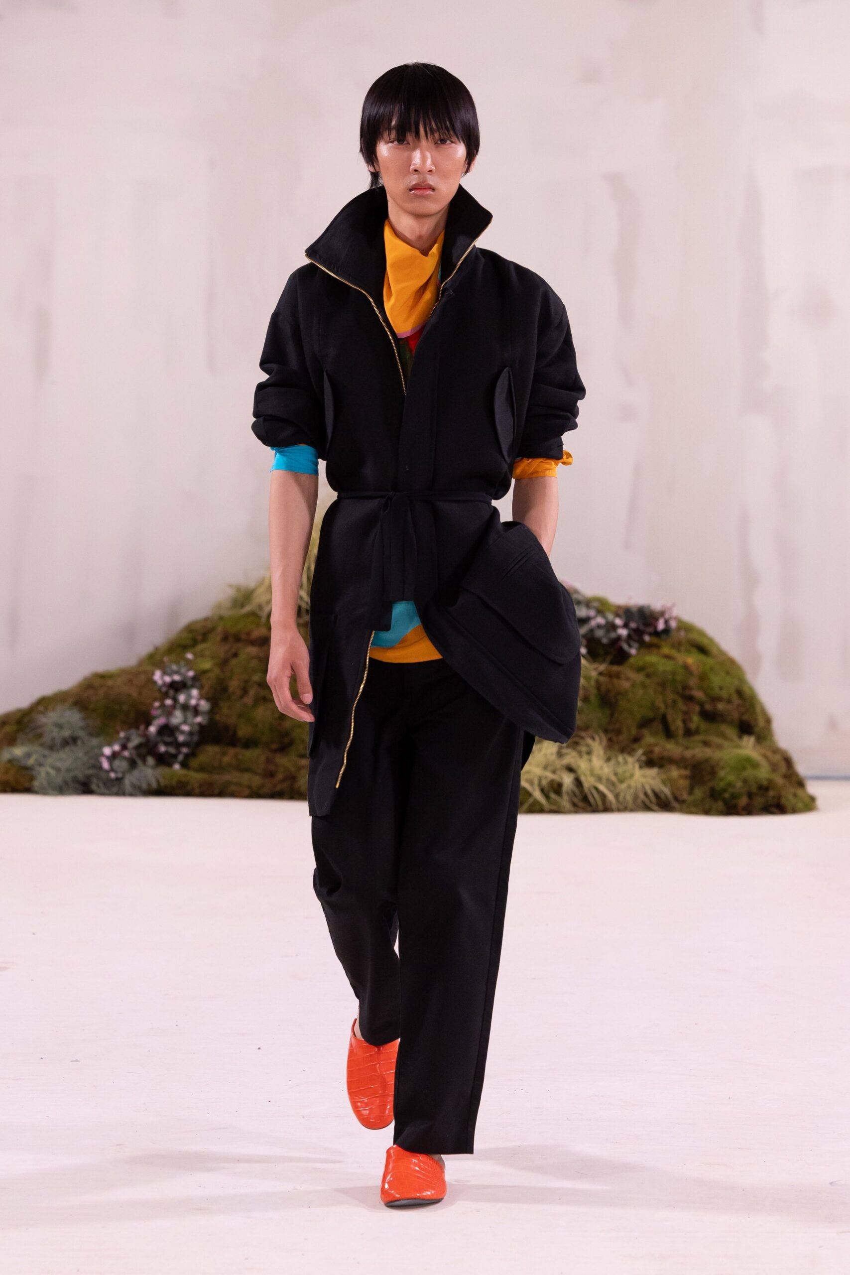 black jacket orange top tailored pants