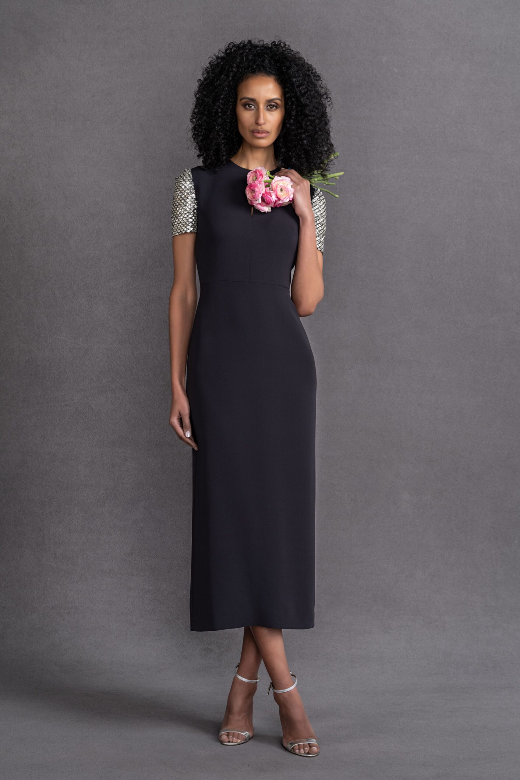 black fitted midi dress with strappy shoes