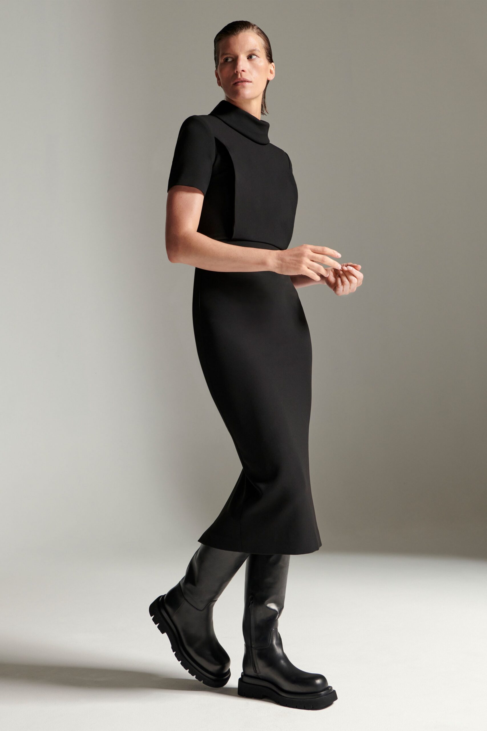 black fitted midi dress with boots