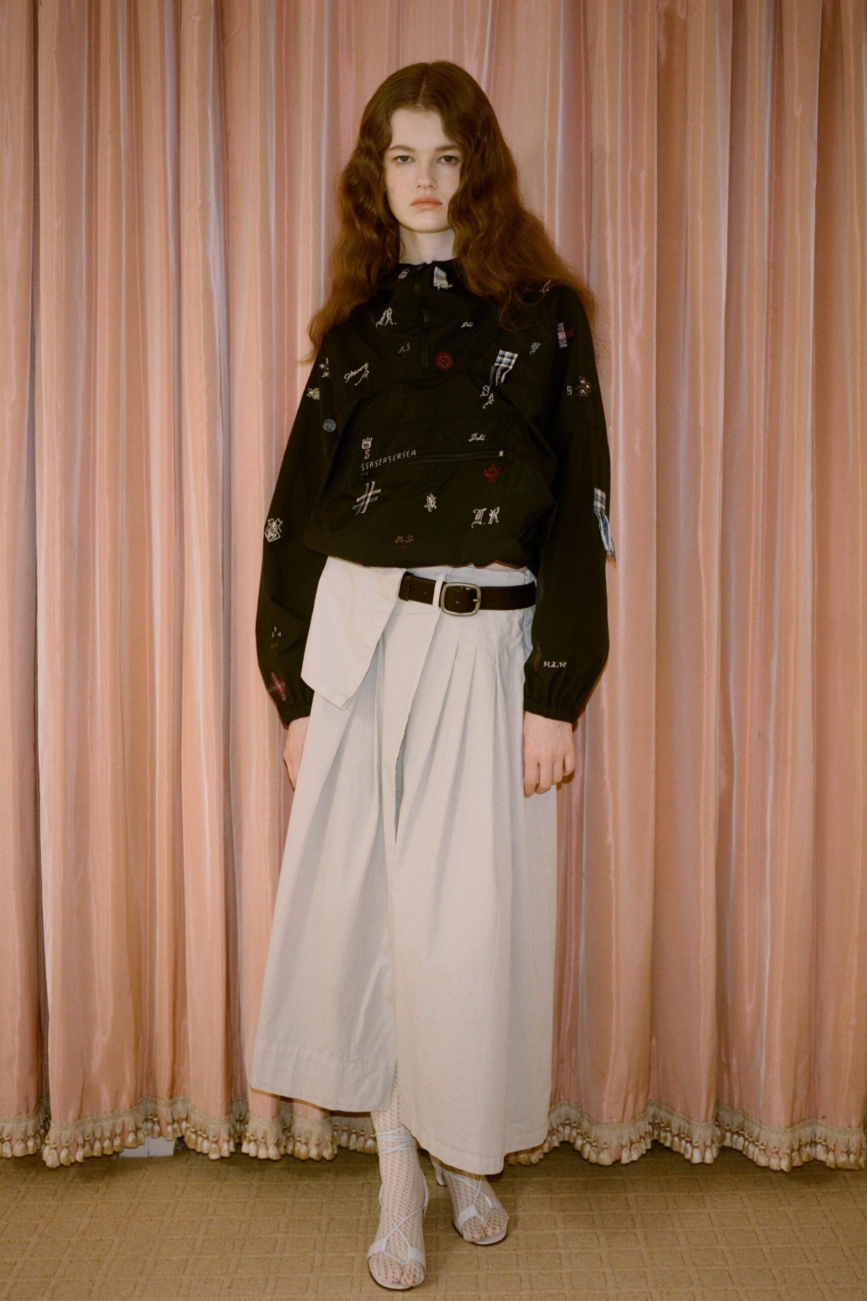 black embroidered blouse gray pleated skirt