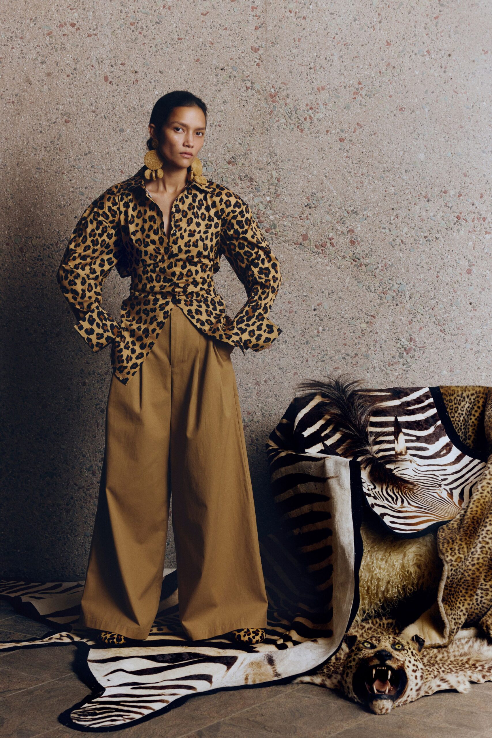 animal-print shirt and beige pants