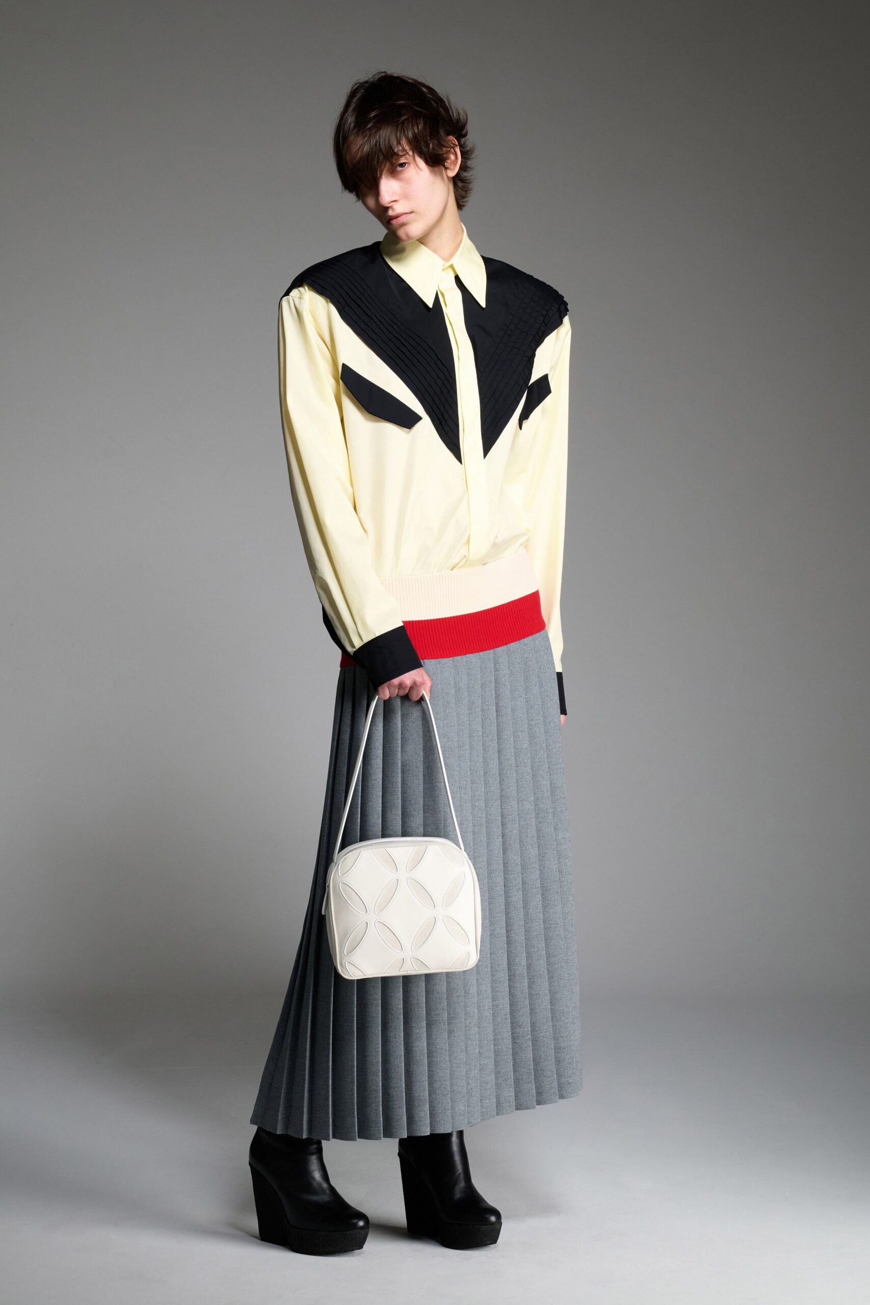 yellow black pleated shirt and gray skirt