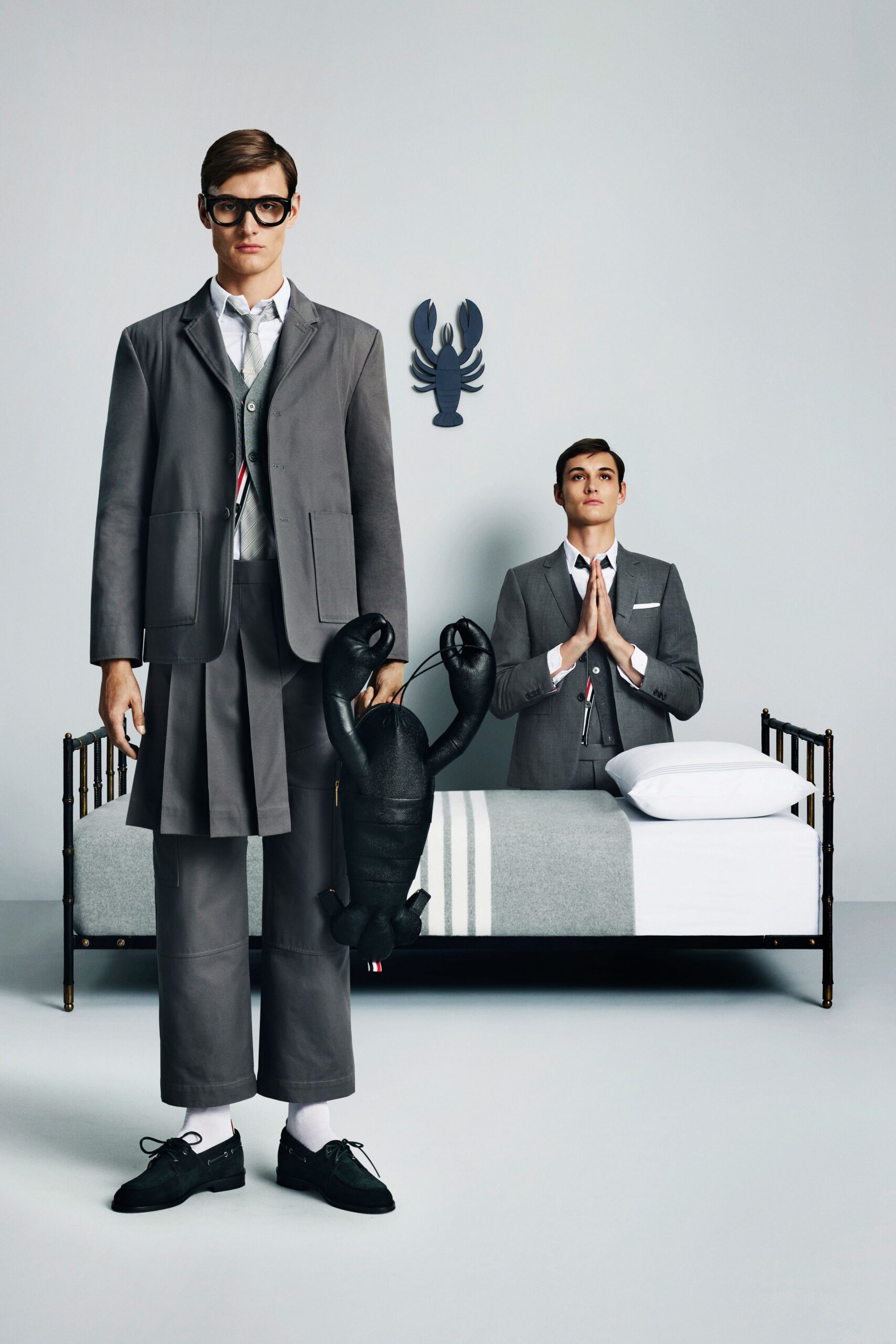 gray tailored suit with black bag