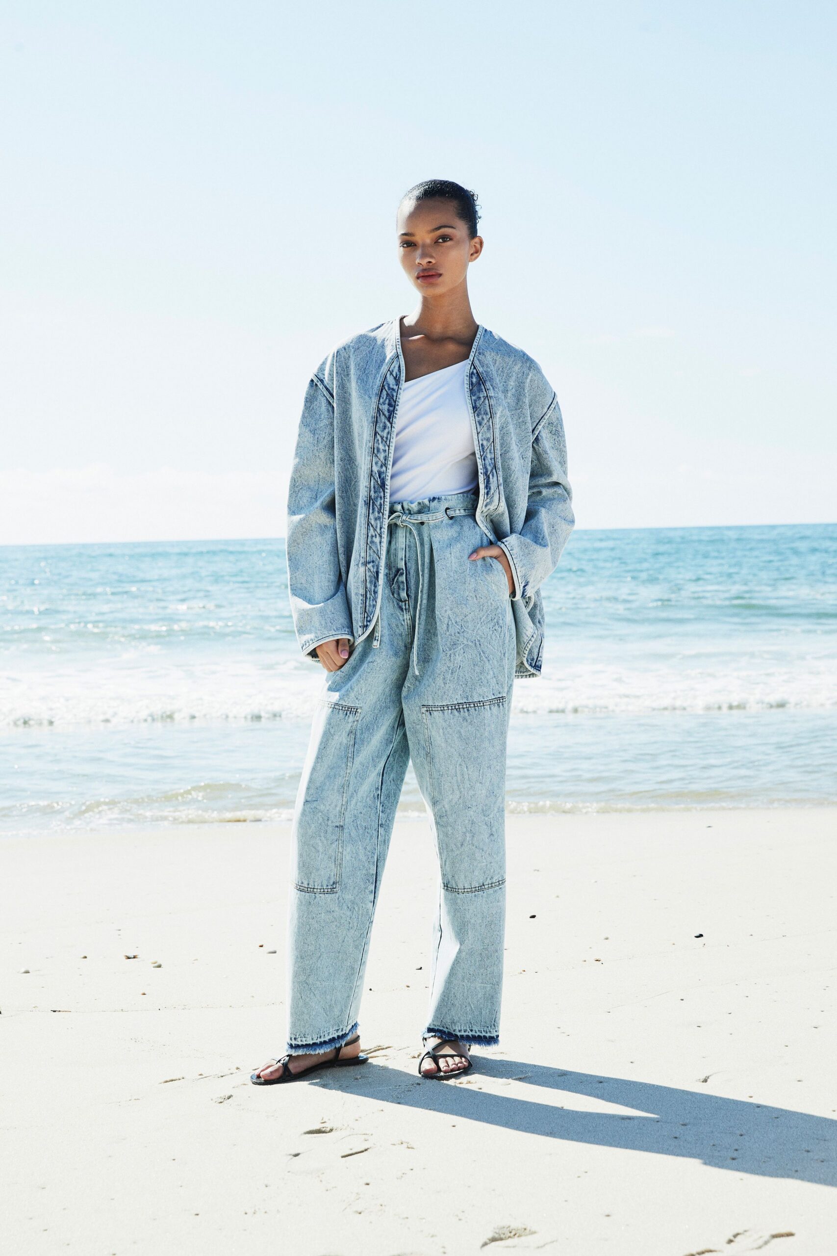denim jacket with white top and relaxed pants