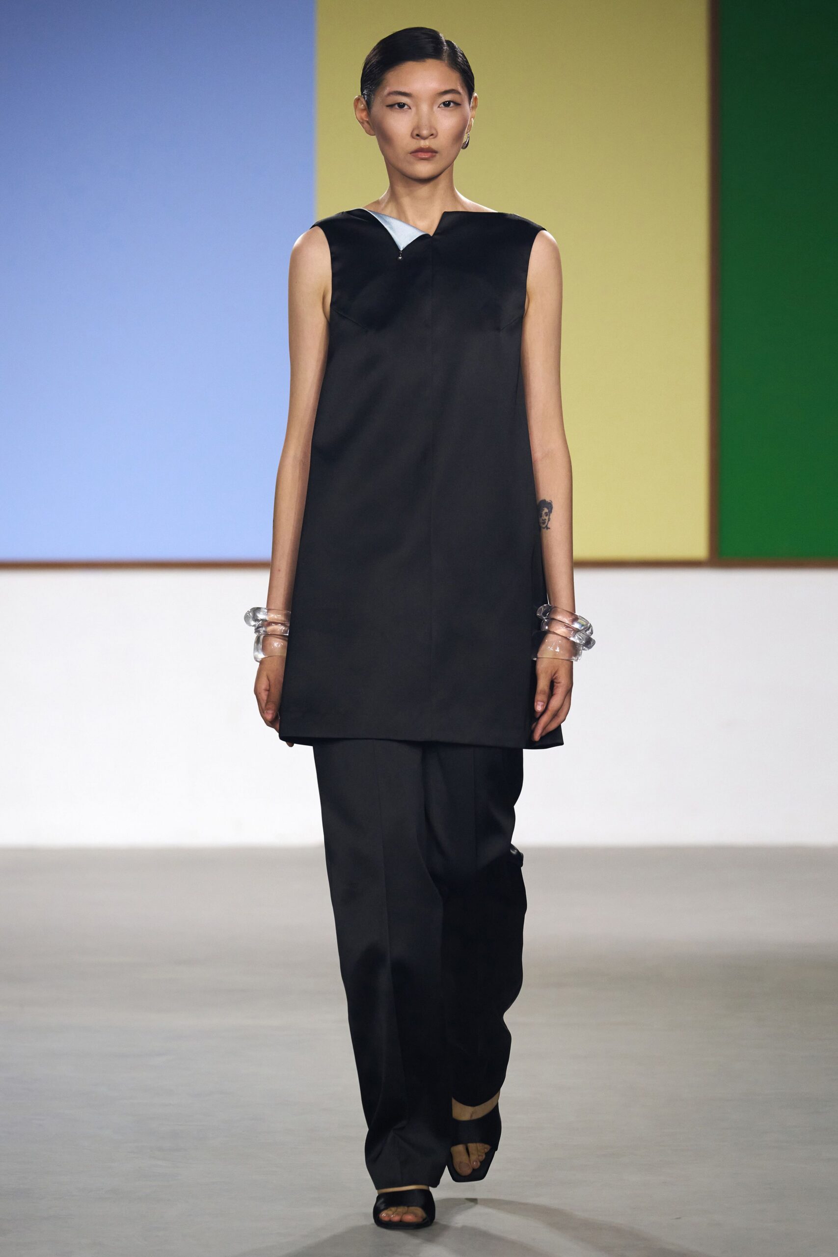 black silk sleeveless top with tailored pants