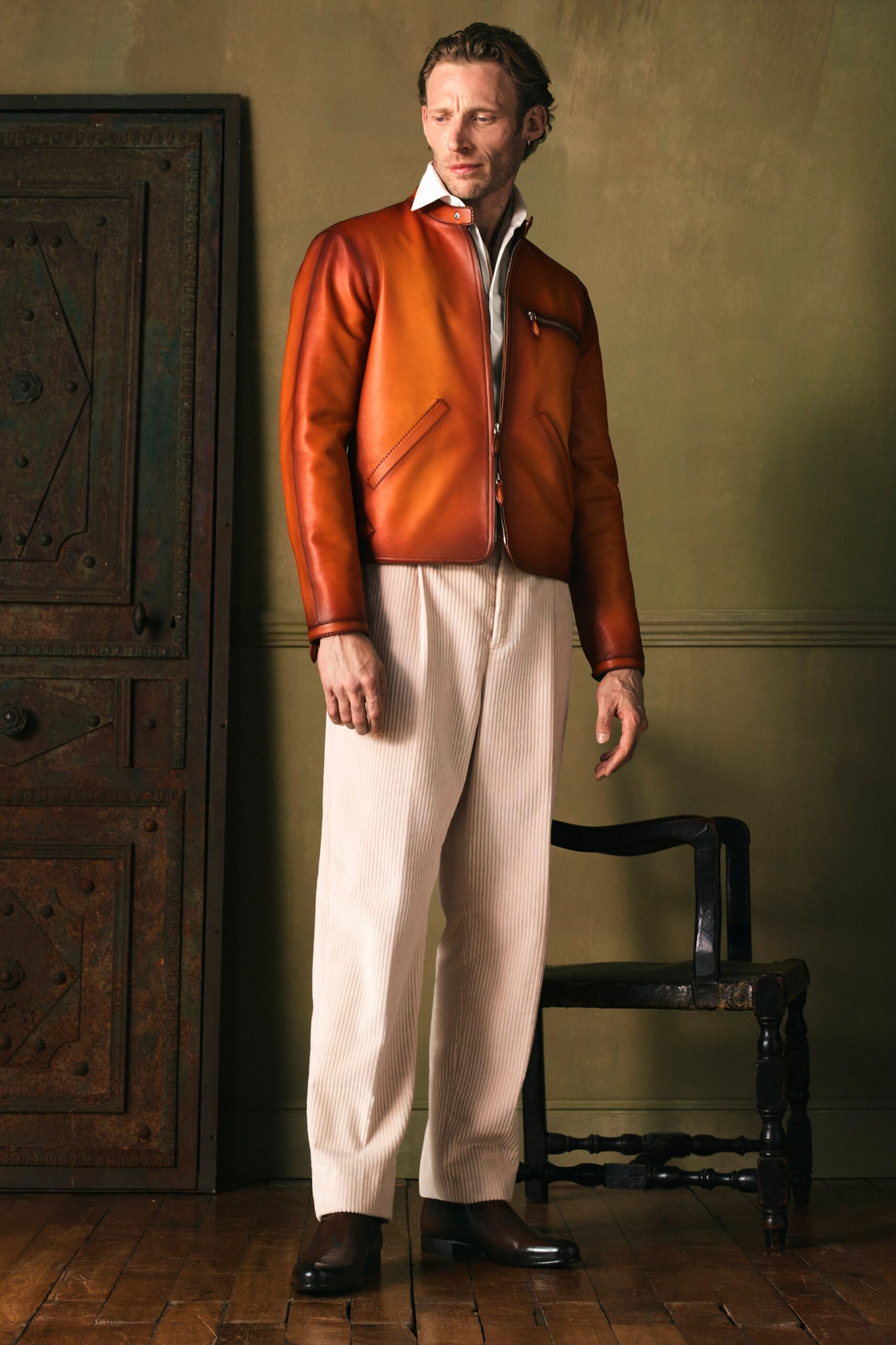 brown leather jacket with beige pants