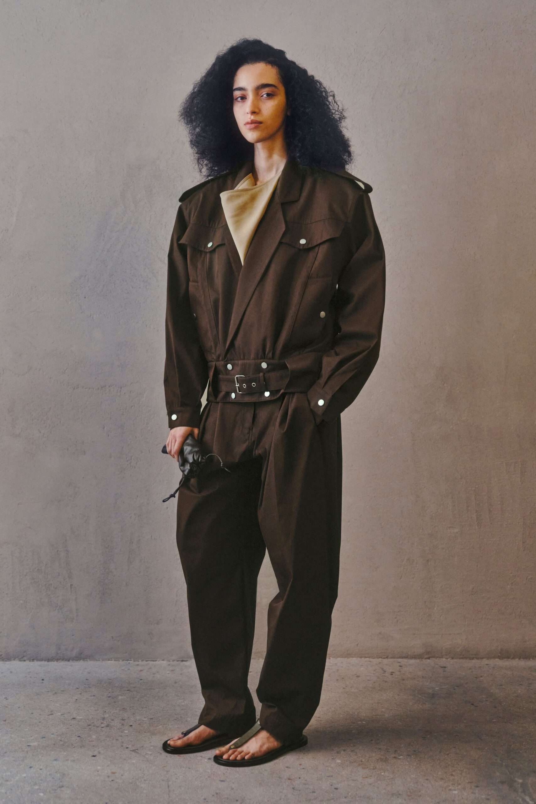 brown relaxed jumpsuit with black shoes