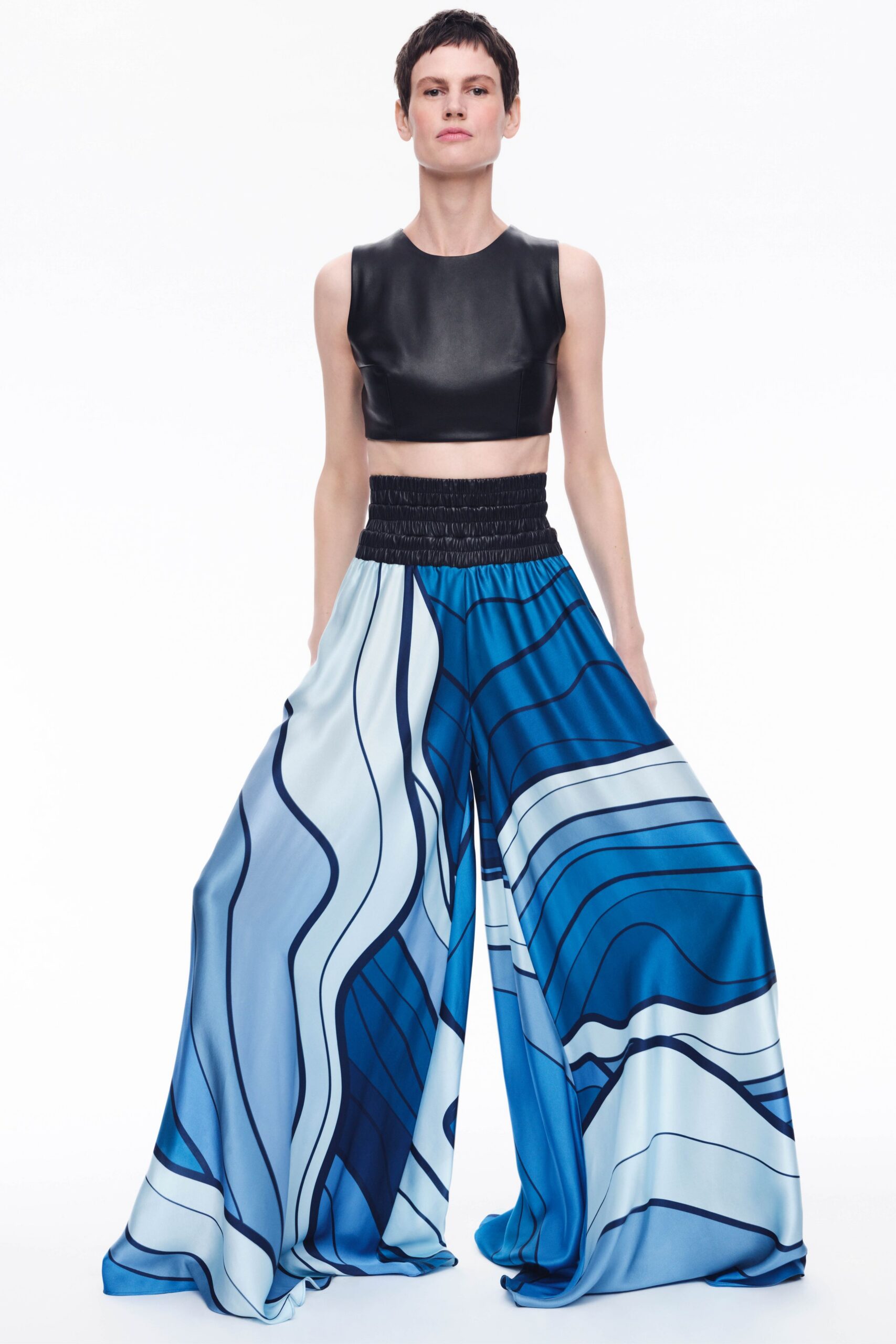 black leather crop-top with blue printed pants