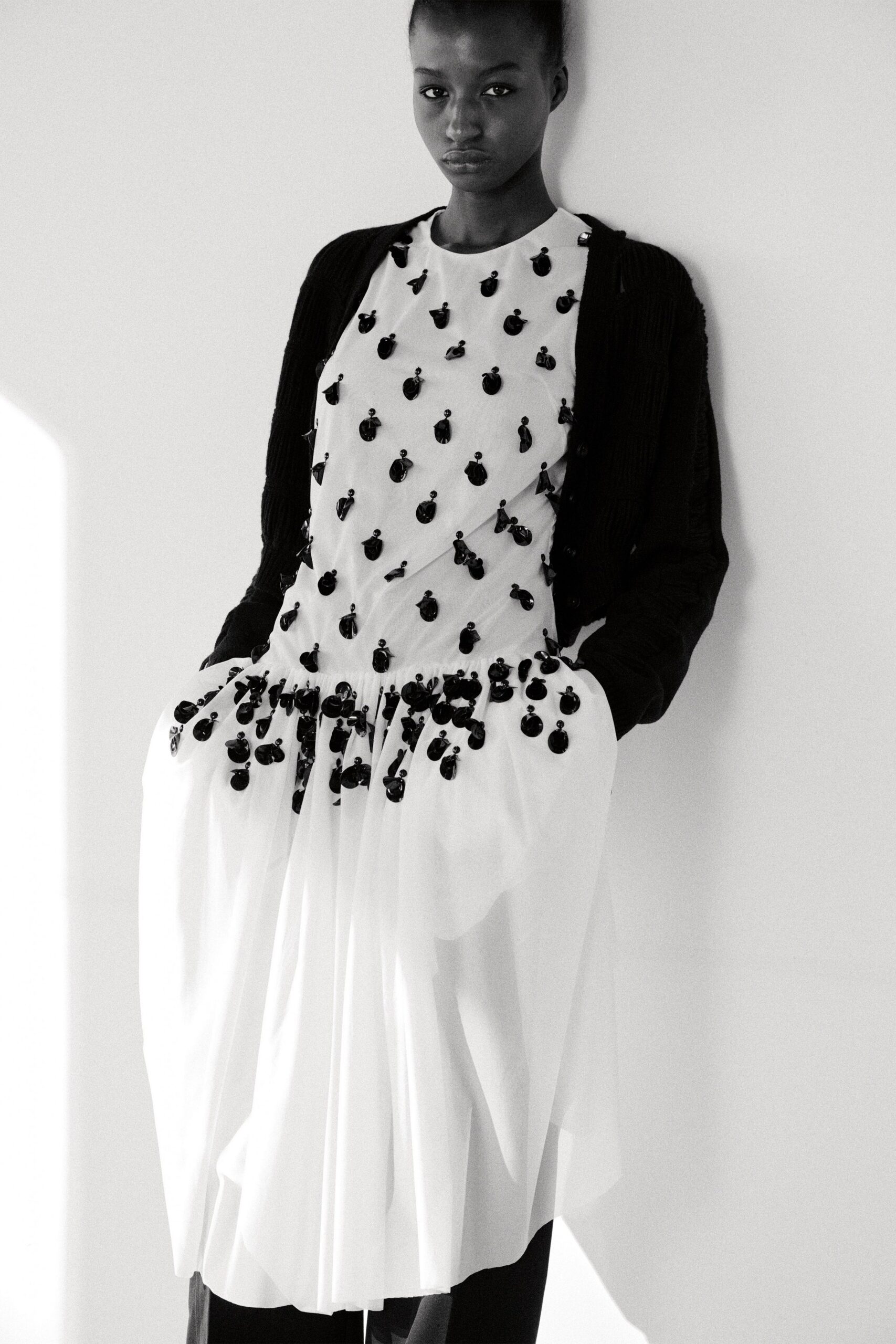 black cardigan over white dress
