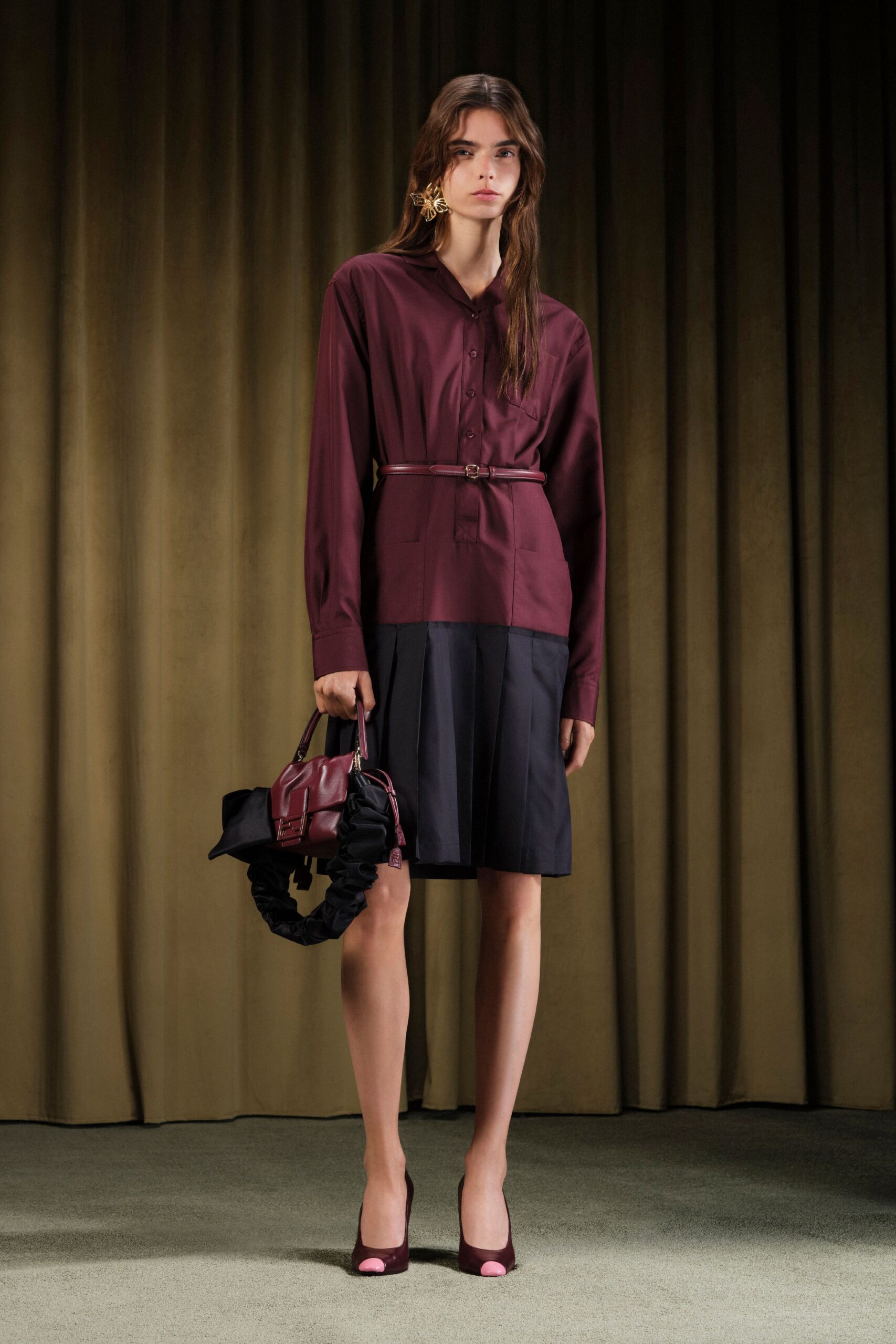 maroon shirt black pleated skirt
