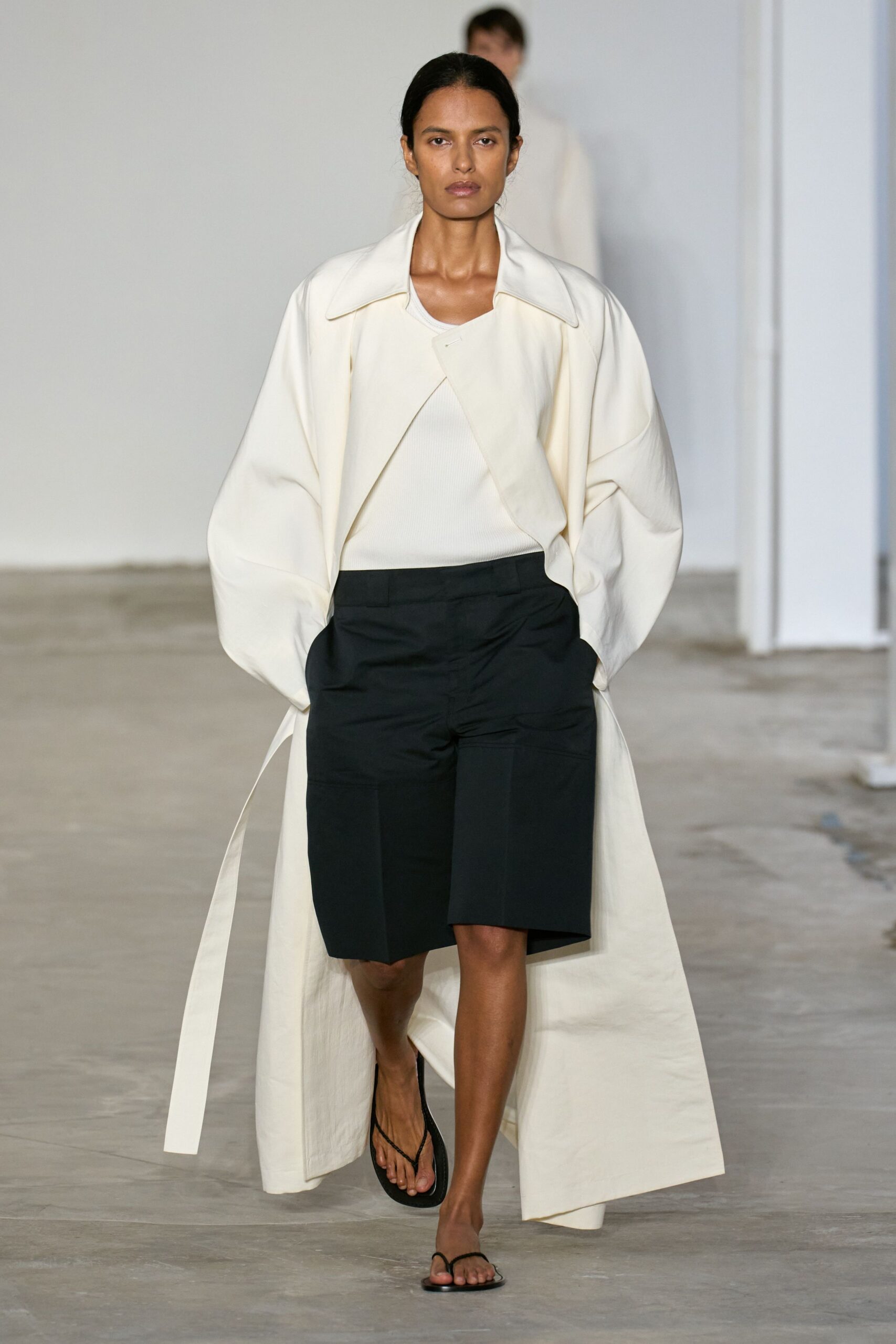 white coat black shorts outfit