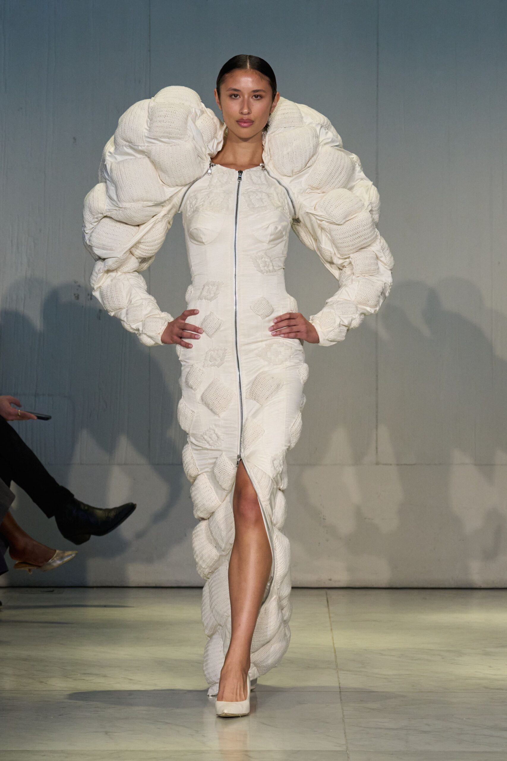 white pleated gown with dramatic sleeves