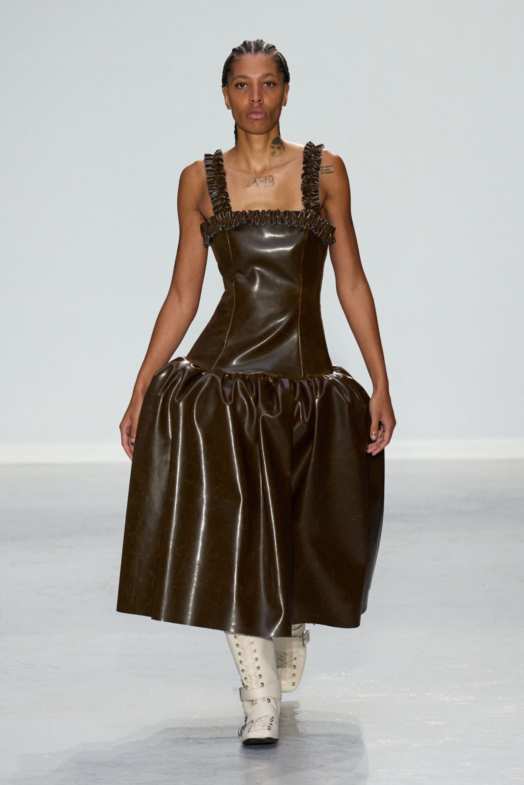 brown leather sleeveless dress with white boots