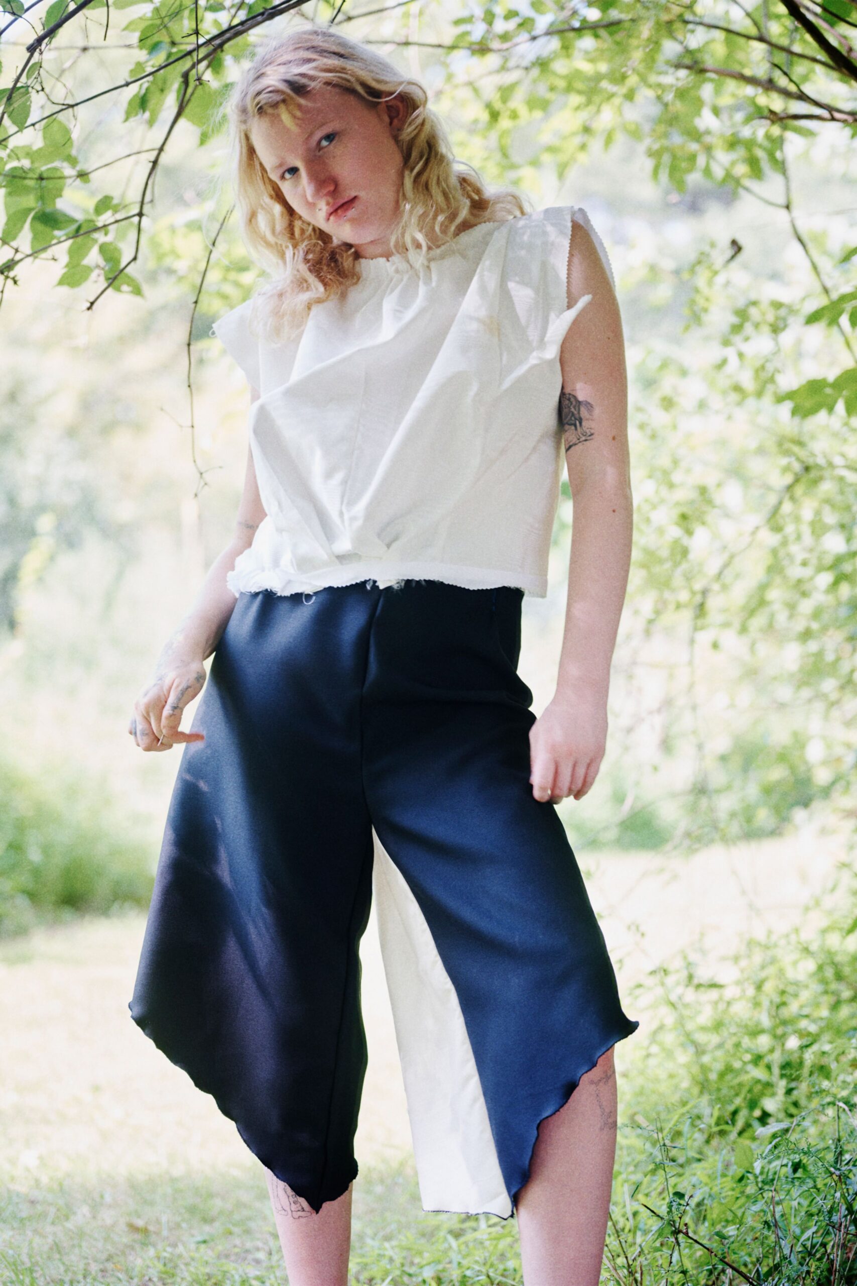 white ruffled top with blue pants